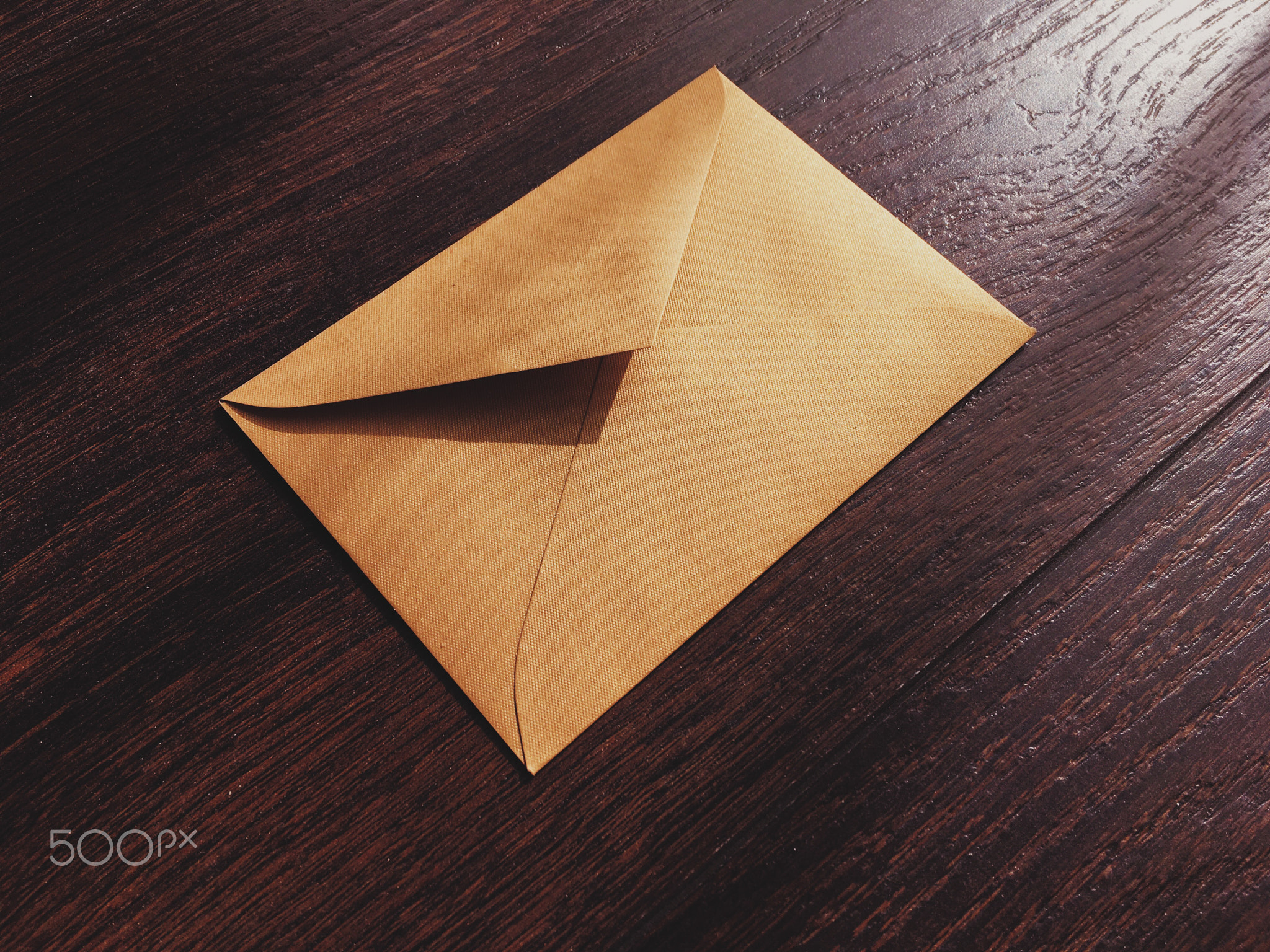 Golden vintage envelope on wooden background, newsletter and message