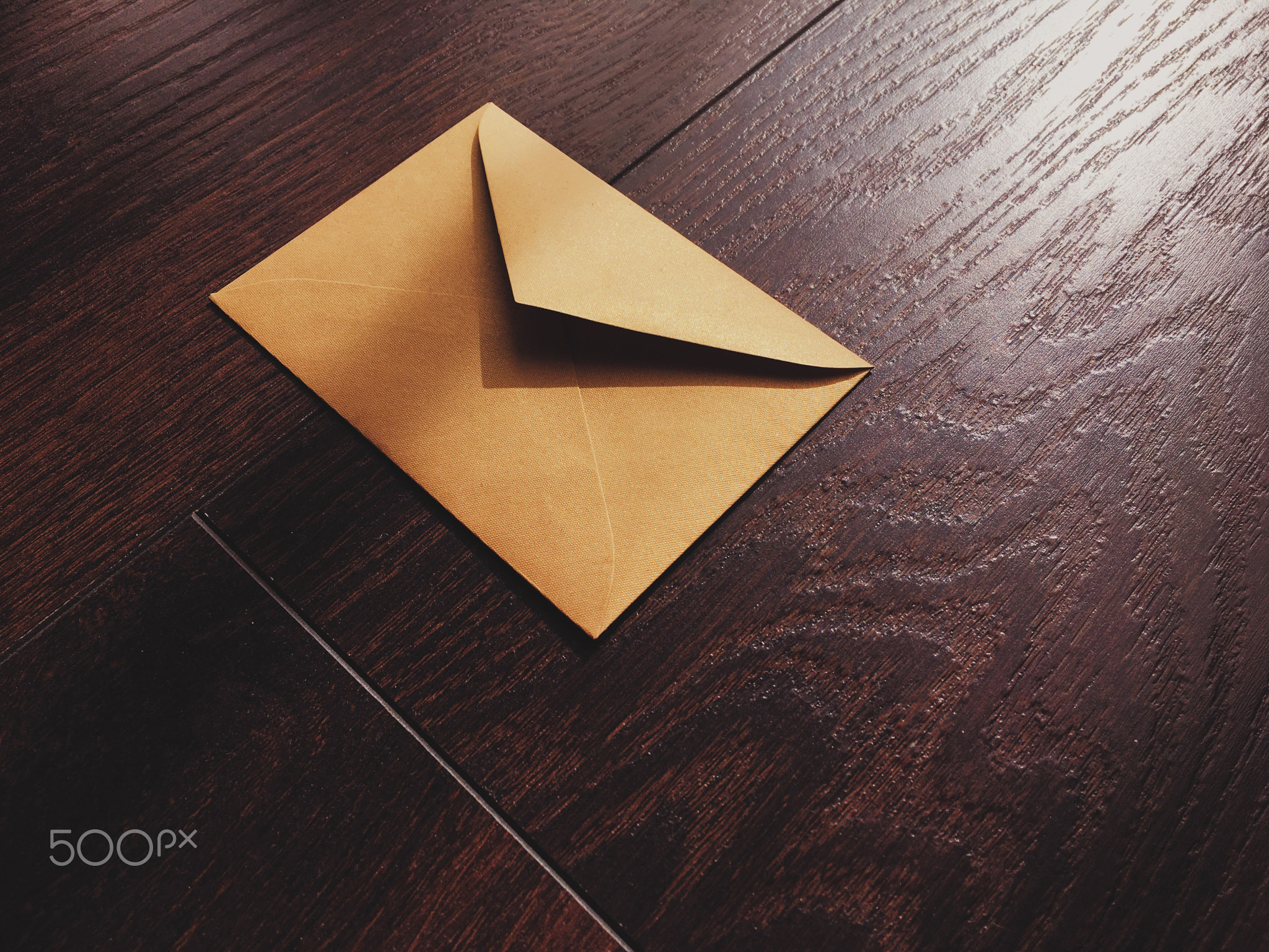 Golden vintage envelope on wooden background, newsletter and message