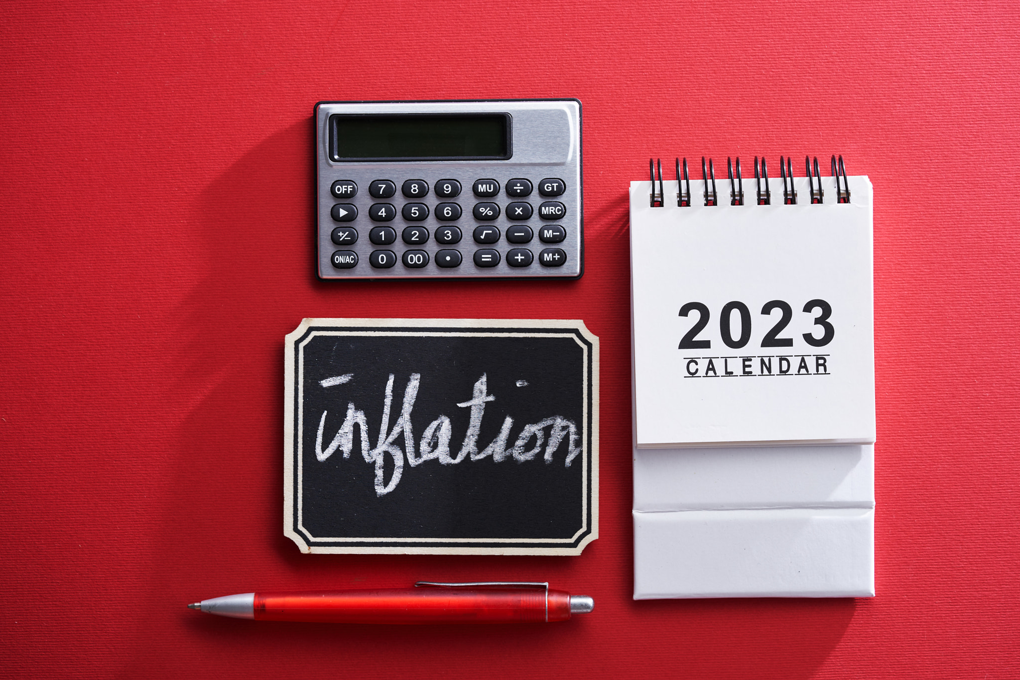 2023 calendar,calculator and small chalkboard with text inflation