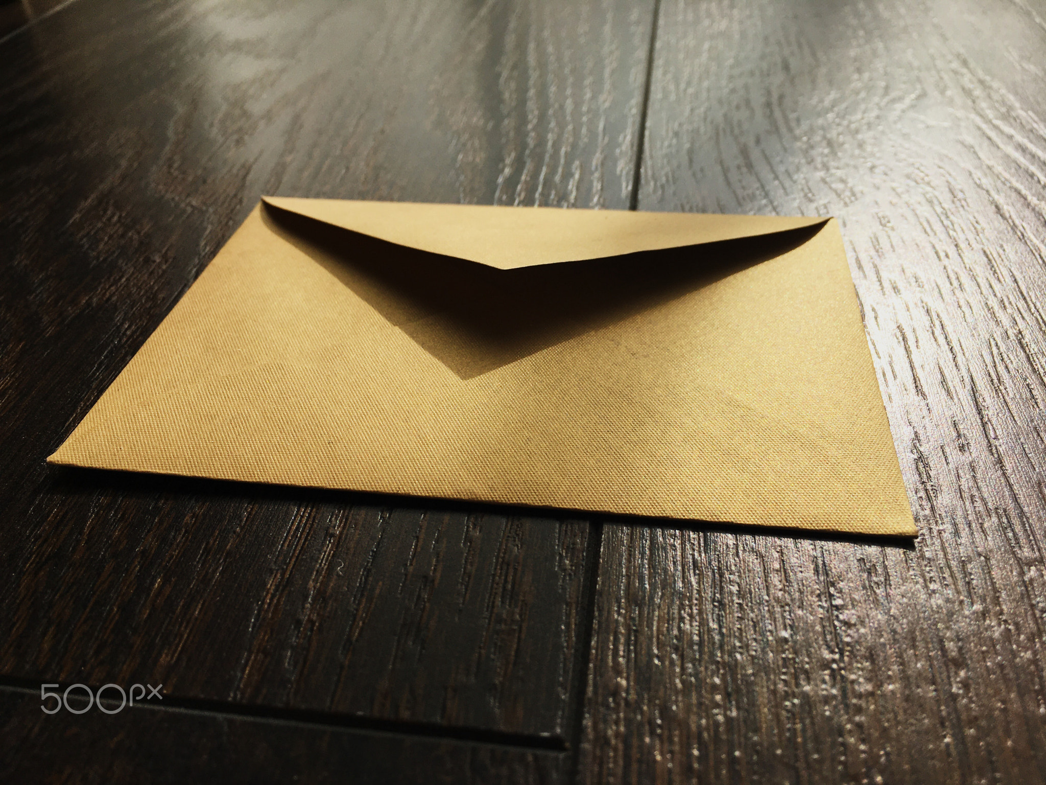 Golden envelope on wooden background, news and communication
