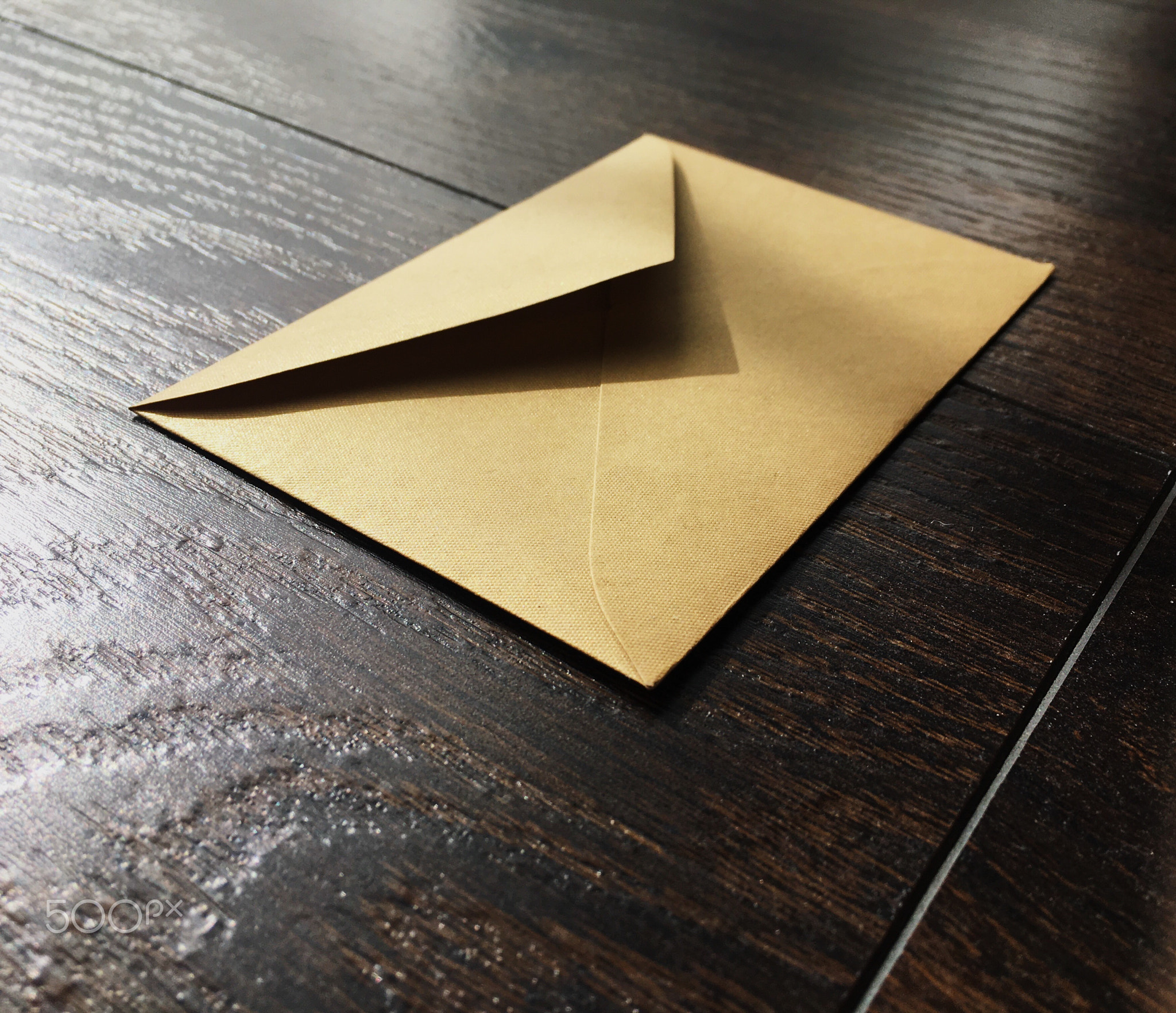 Golden envelope on wooden background, news and communication