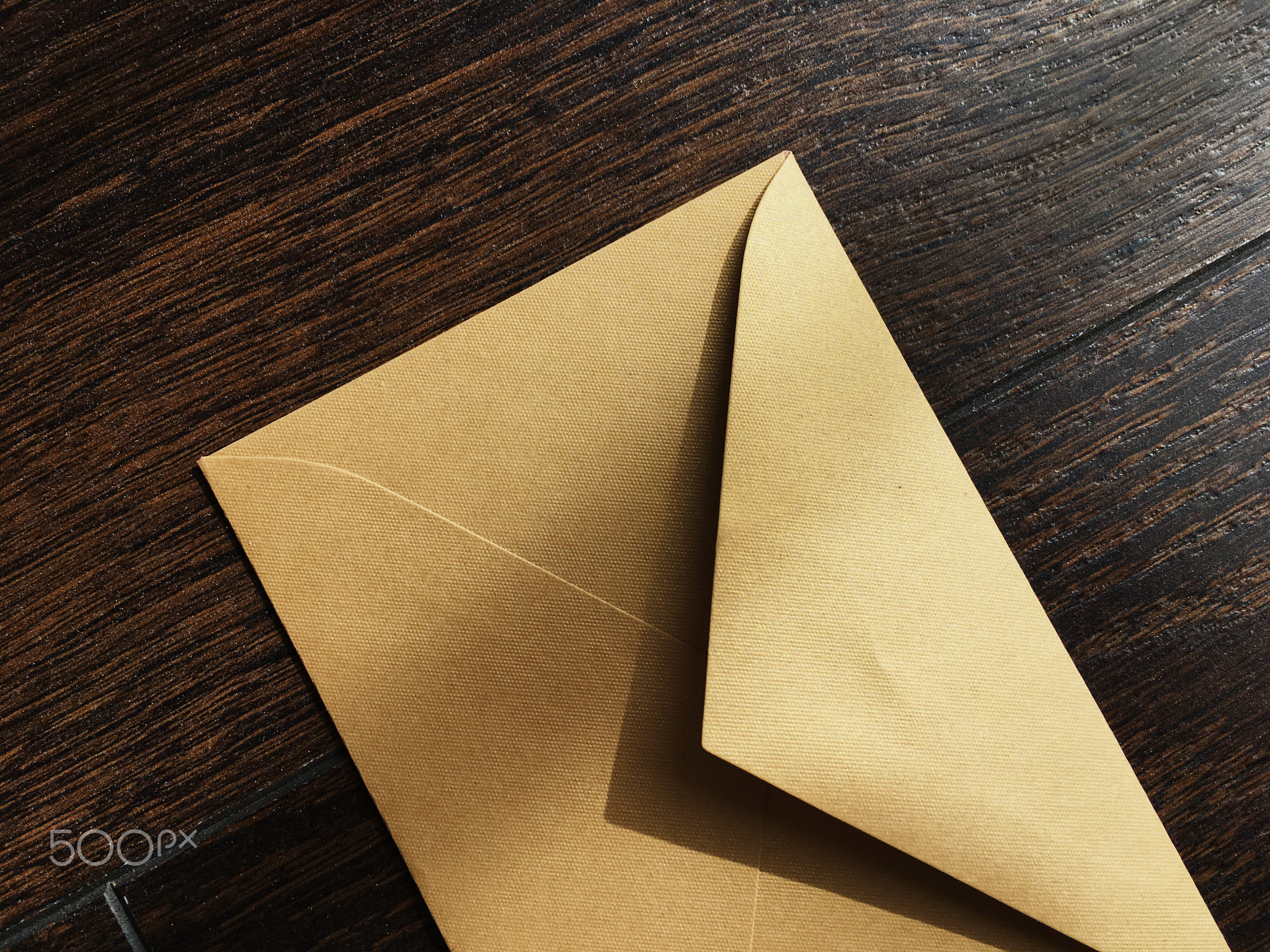 Golden envelope on wooden background, news and communication