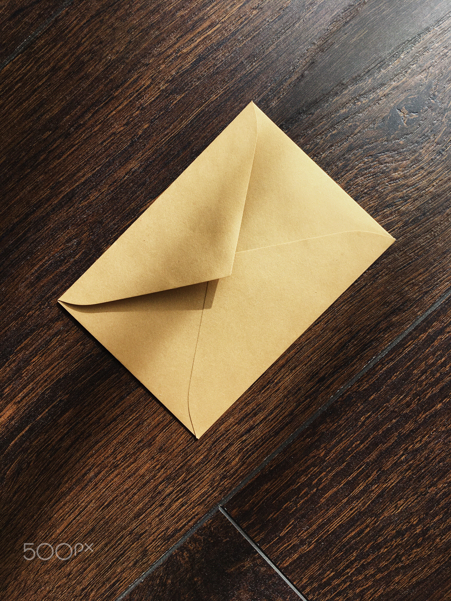 Golden envelope on wooden background, news and communication