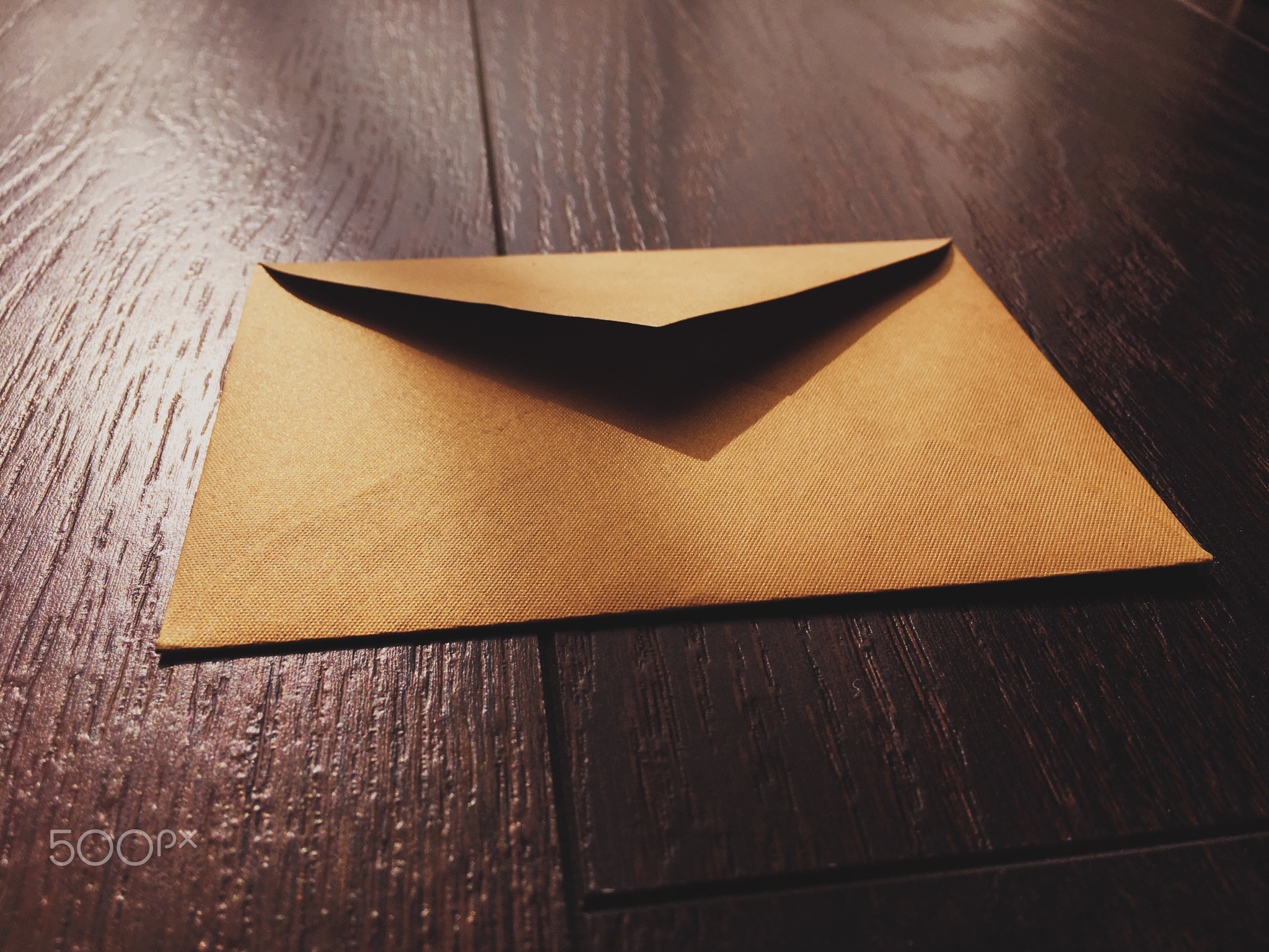 Golden vintage envelope on wooden background, newsletter and message