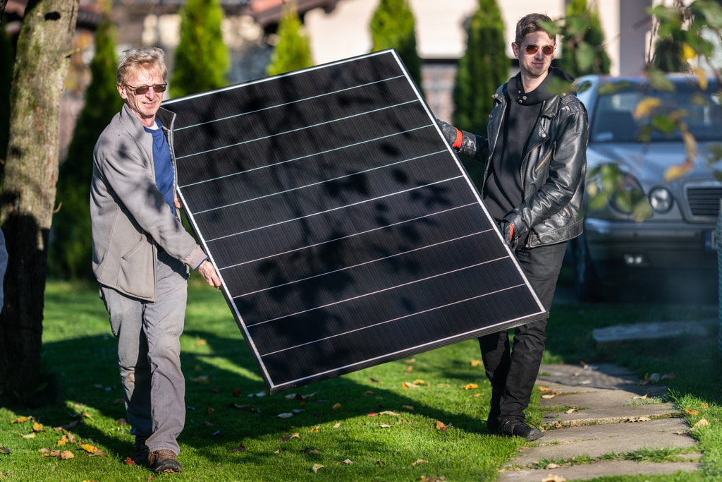 Father and son installing solar panels as a gift to each other by Iza ?yso? on 500px.com