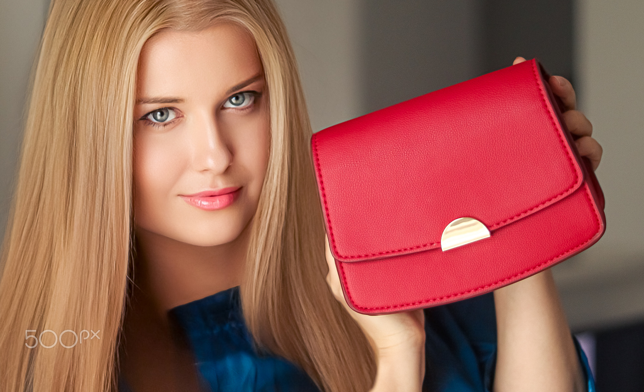 Fashion and accessories, happy beautiful woman holding small red