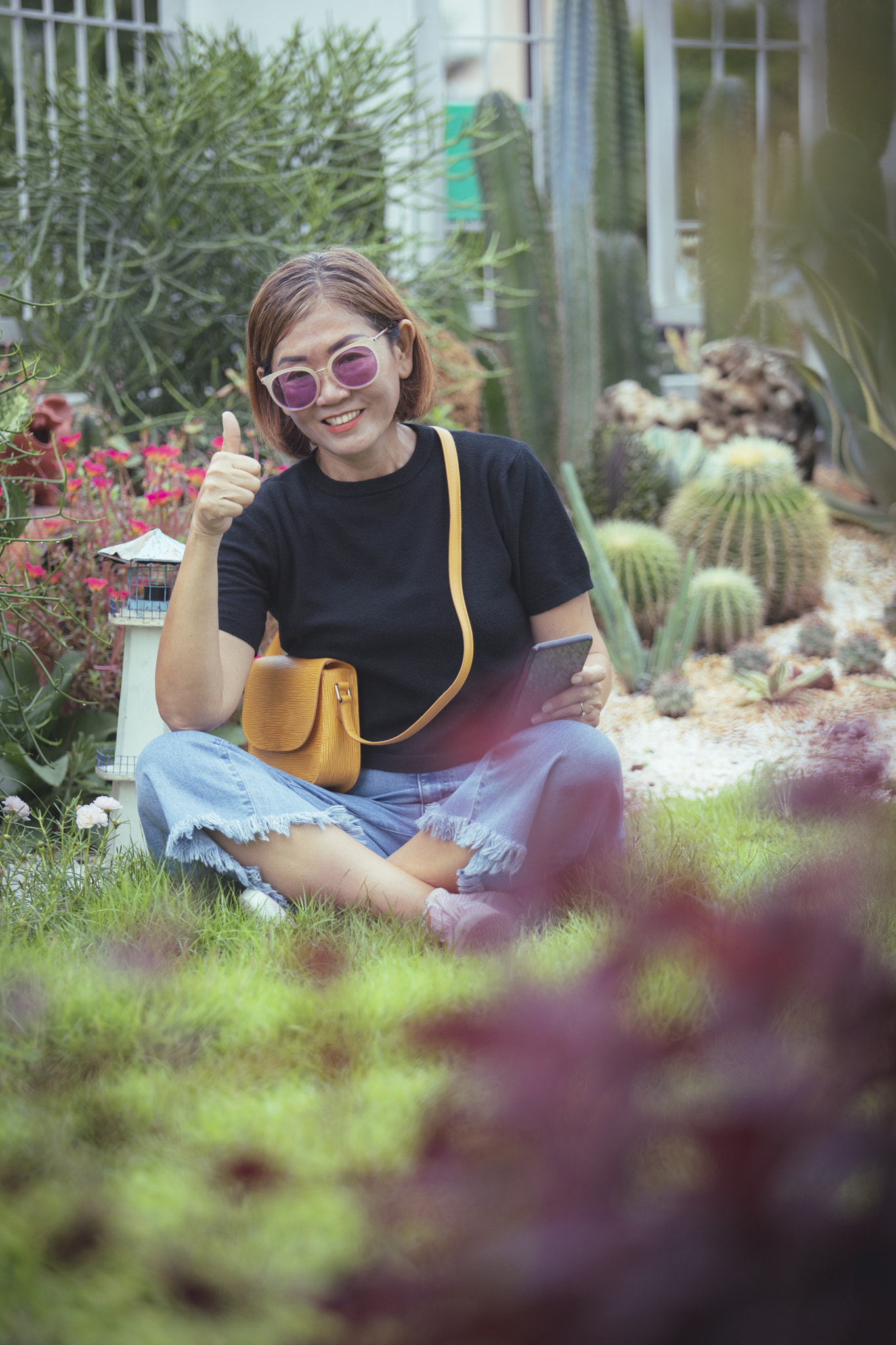 asian woman toothy smiling with happiness sitting in home garden