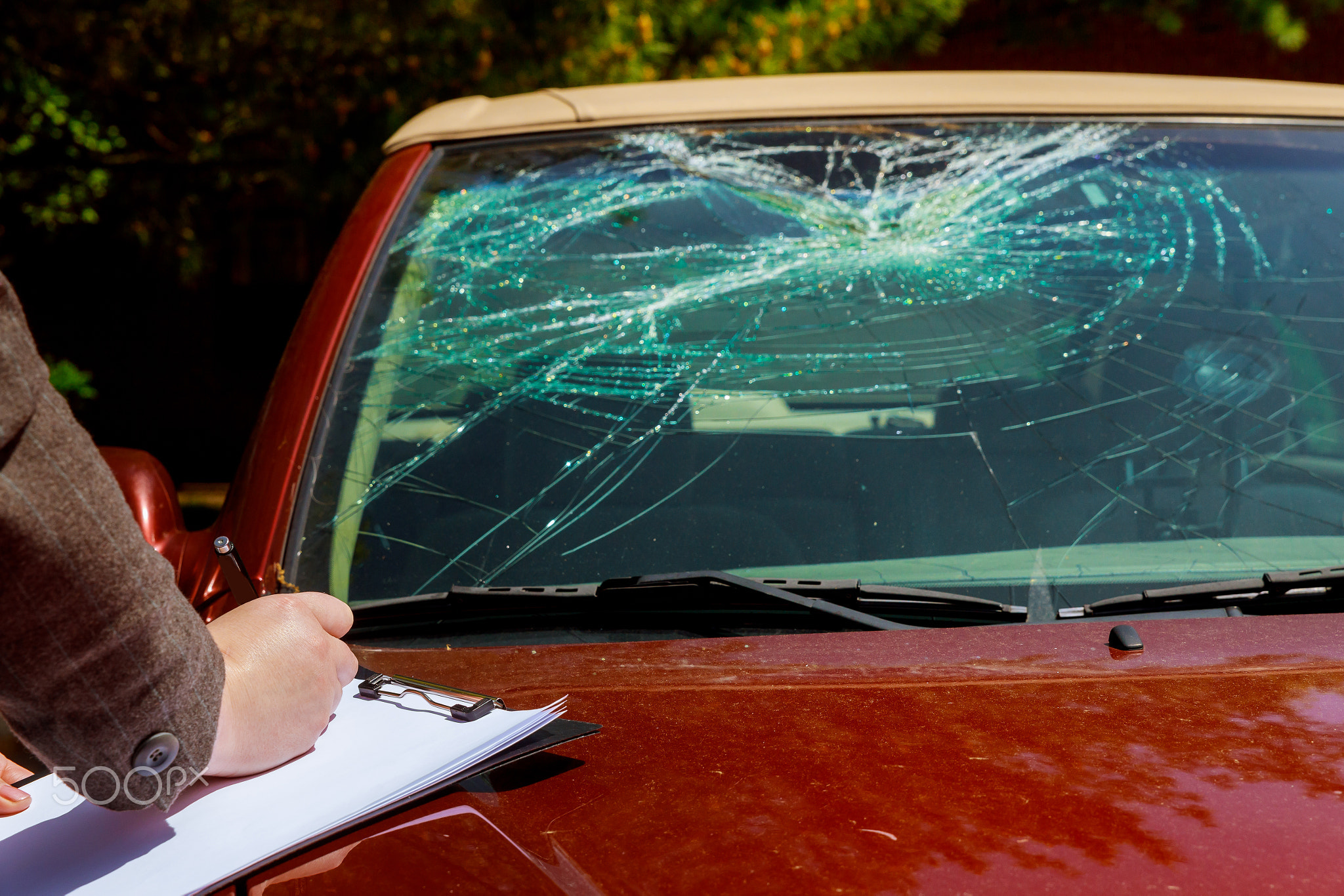 Insurance agent estimates the cost of damaged car after clash with a