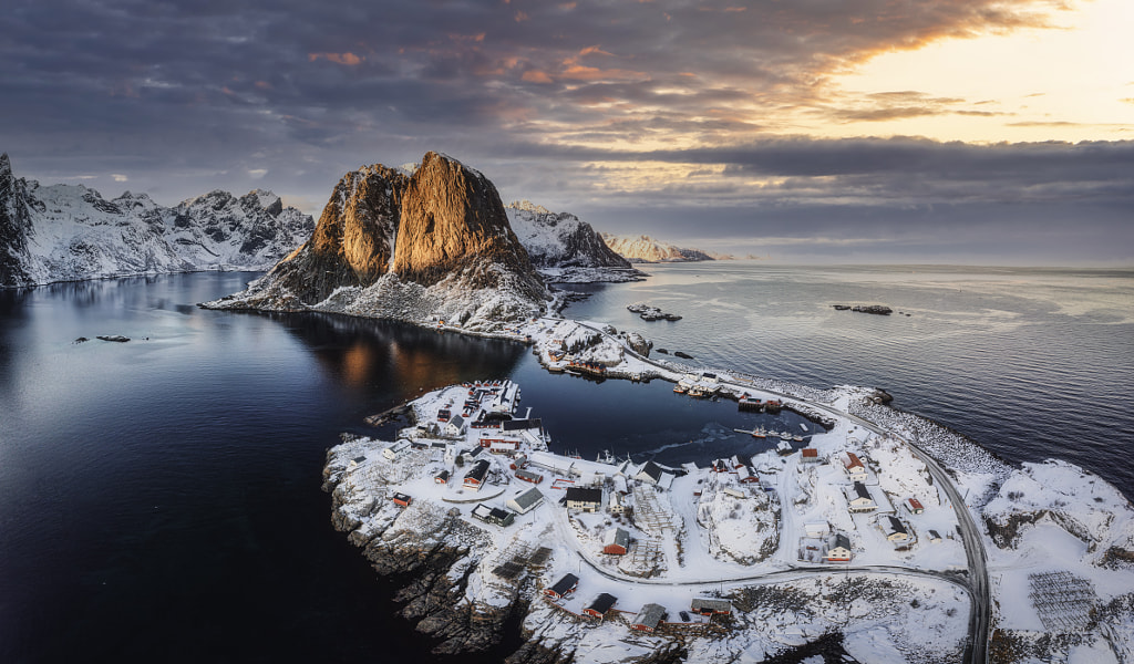 Aerial view of snowy mountain and fishing village on coastline in winter at Lofoten Islands by Thanayu Jongwattanasilkul on 500px.com