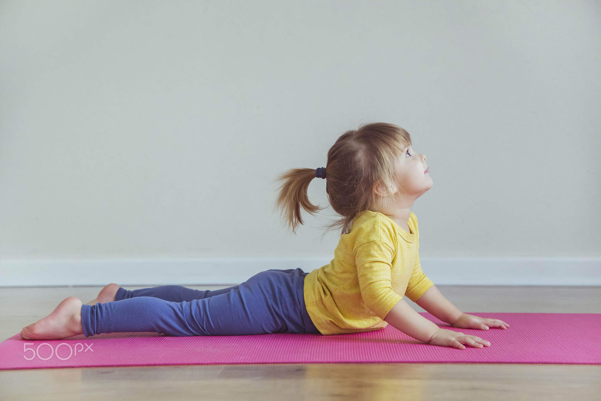Charming baby doing yoga. Place for text
