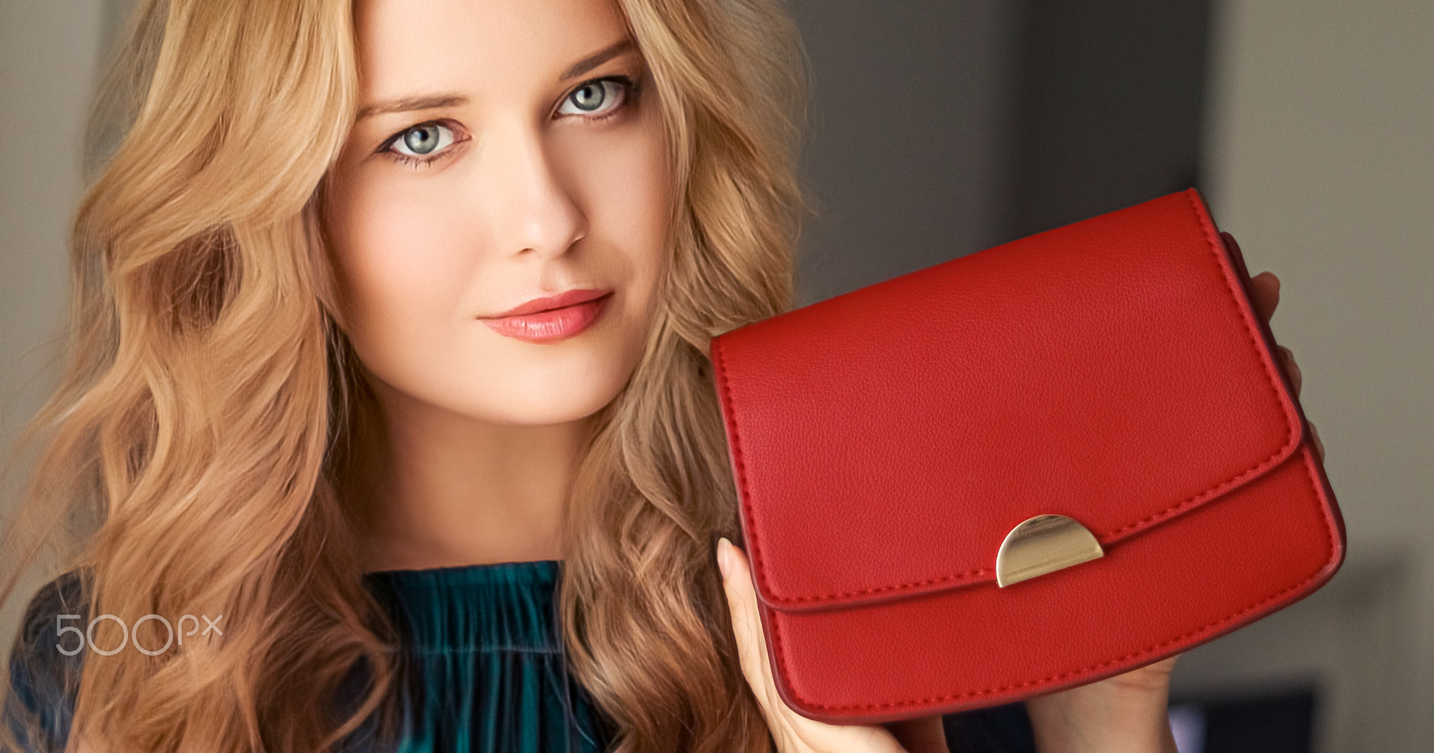 Fashion and accessories, happy beautiful woman holding small red