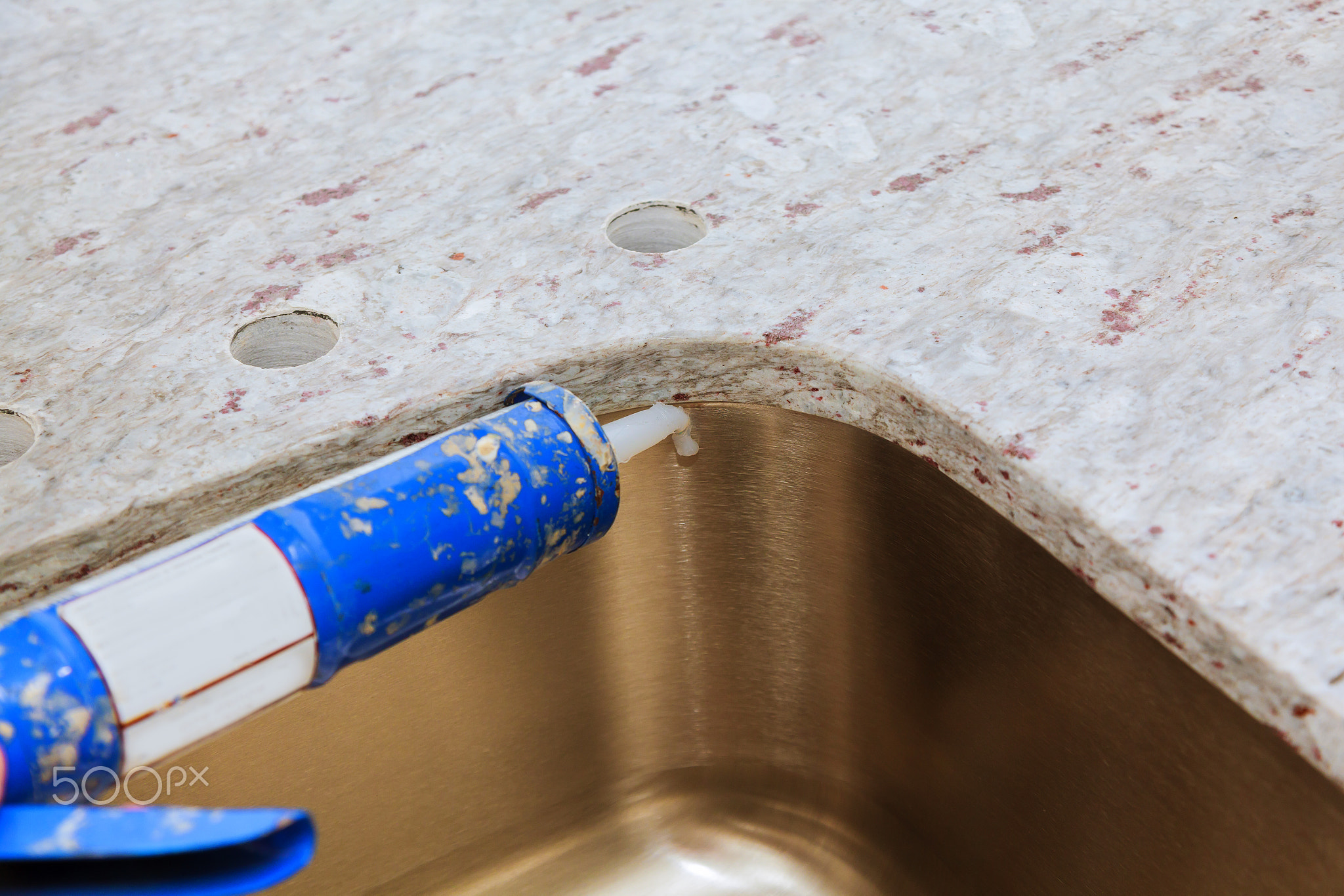 Contractor installed counter tops, and sink are partially
