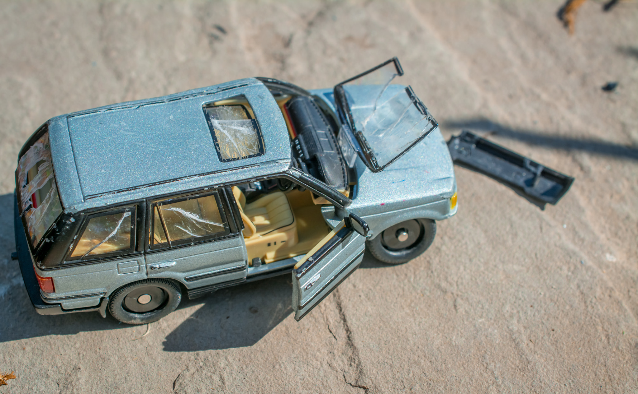 broken toy car on ground