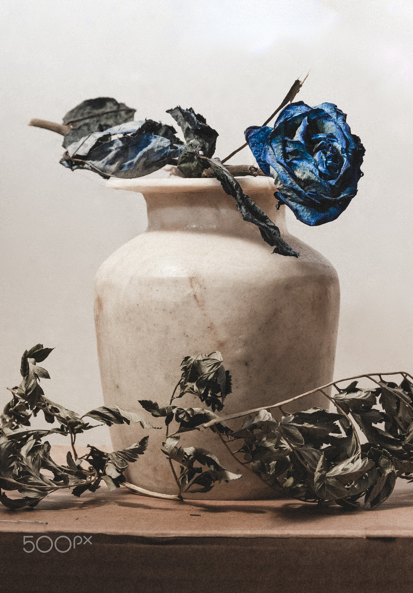 Egyptian alabaster vase with a blue rose