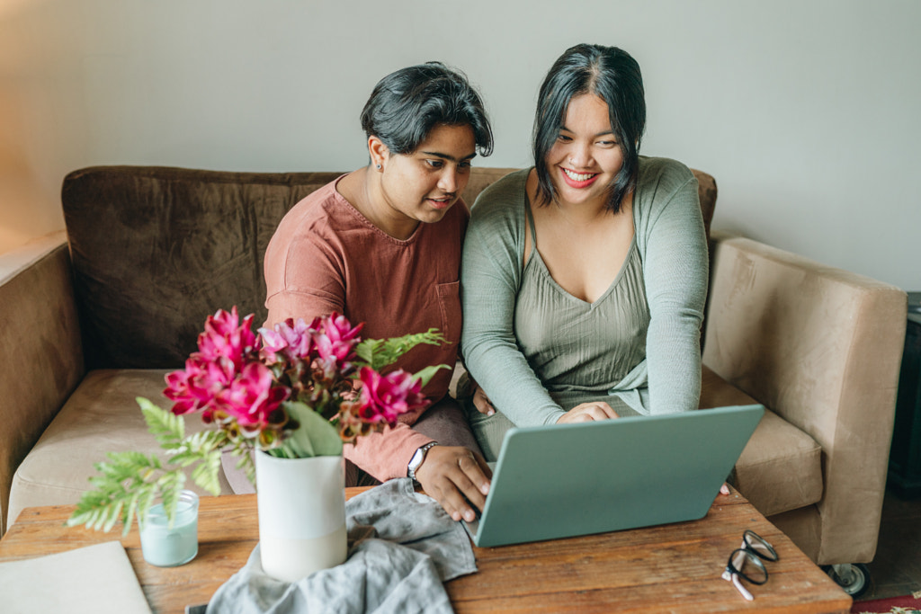 Young couple using laptop at home by Natalie Zotova on 500px.com