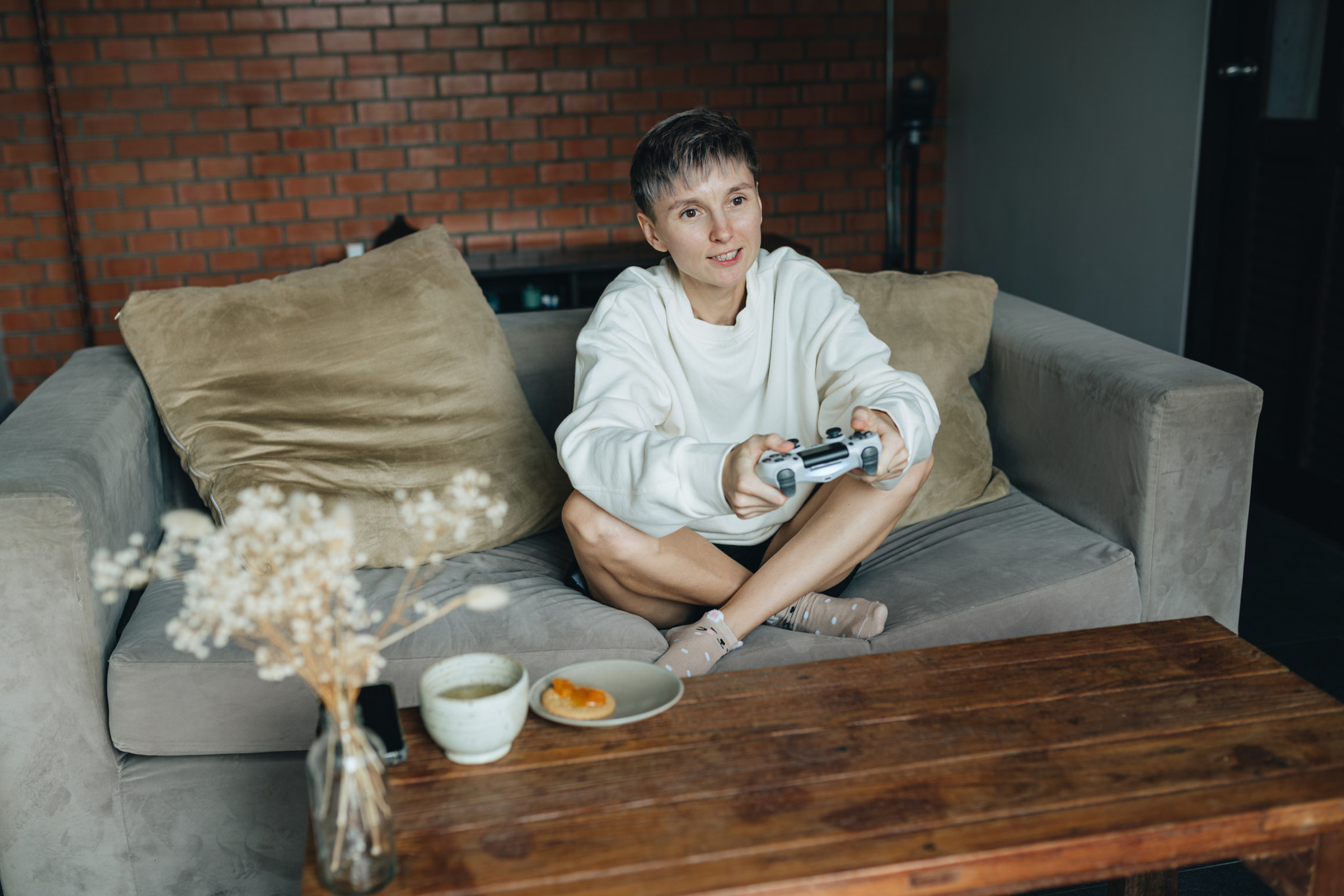 Young adult woman playing video game