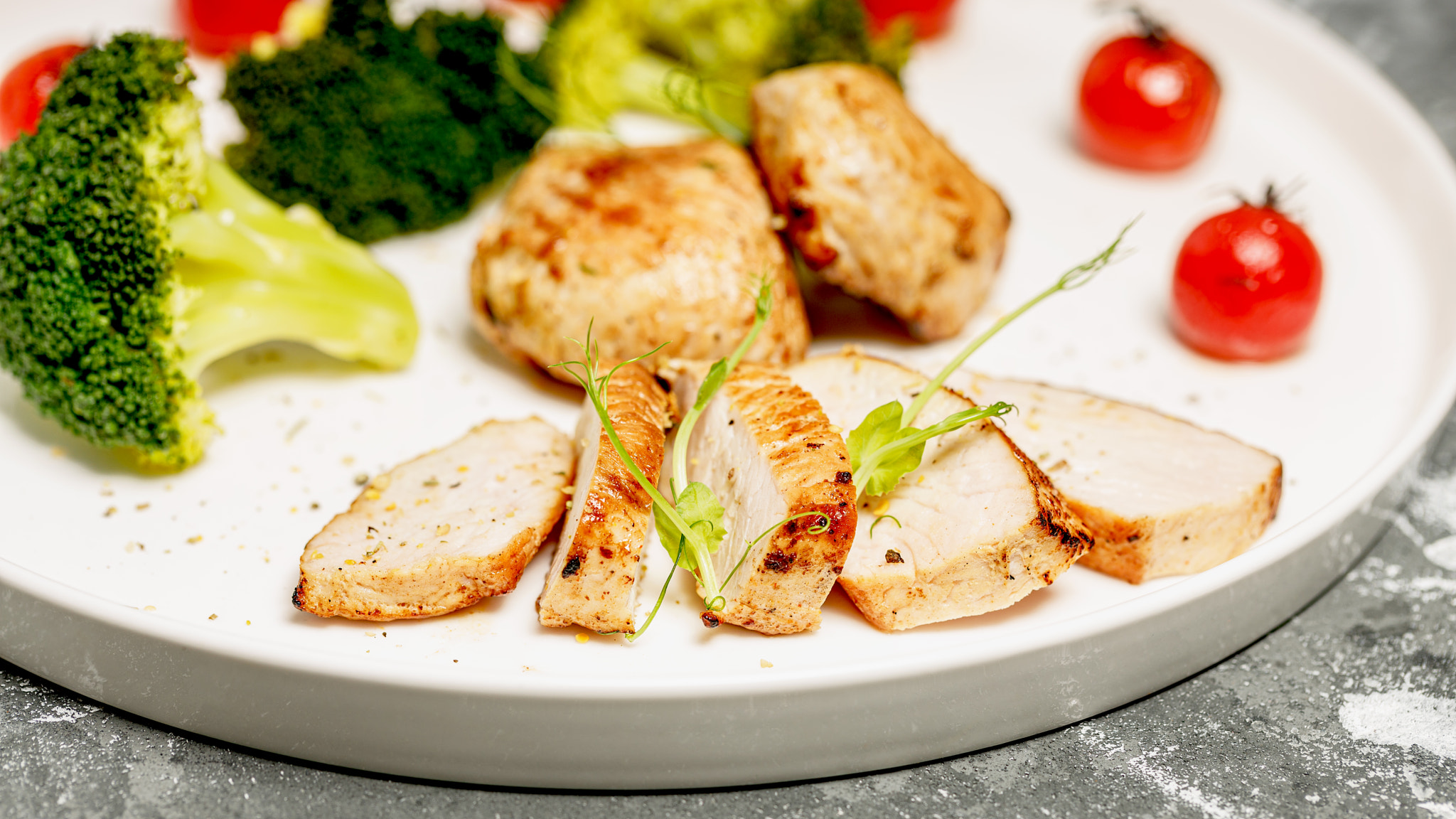 Close-up Turkey breast meat and broccoli on a white plate.