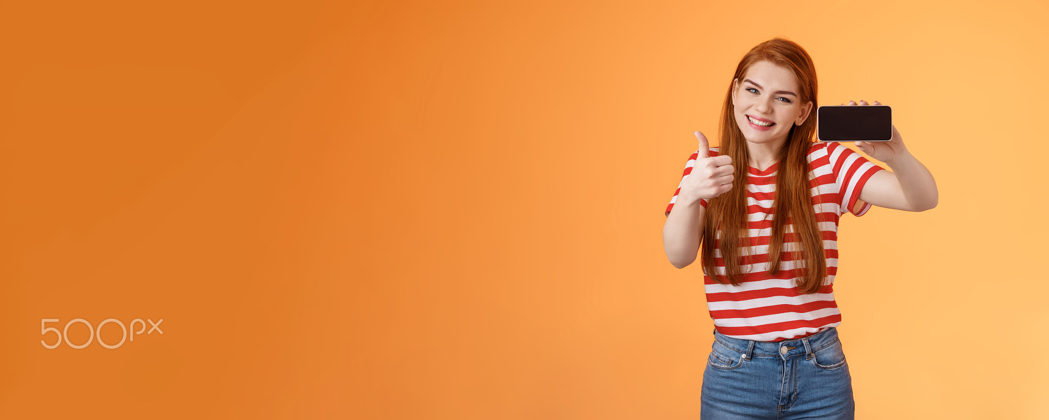 Excited cheerful redhead attractive woman delighted, show thumb up