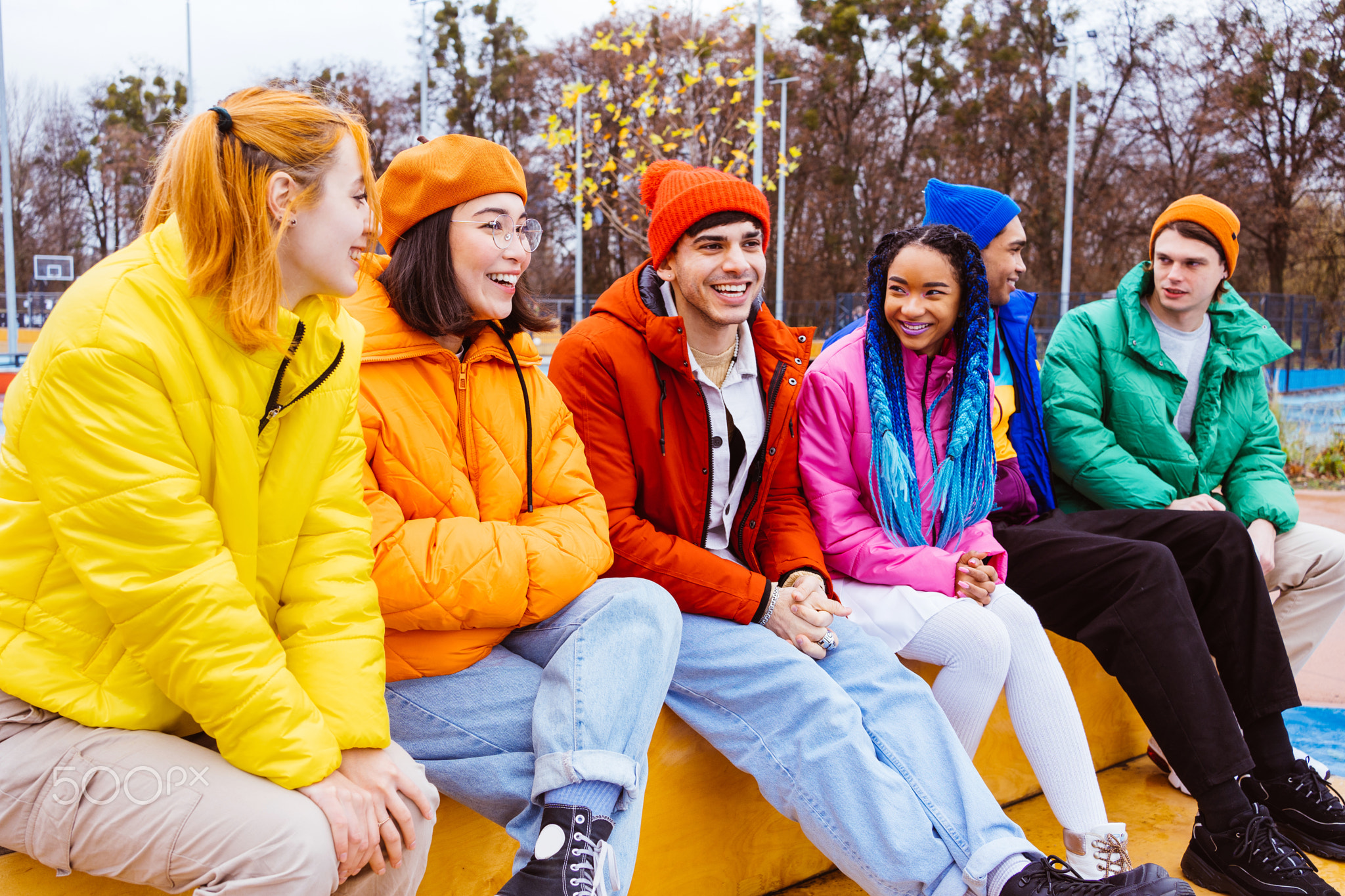 Multiracial group of young friends meeting outdoors in winter