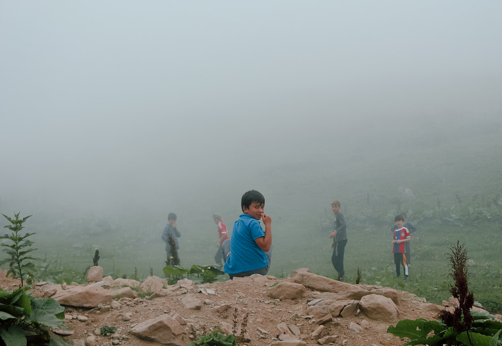 Rear view of people standing on mountain during foggy weather by Nika Pailodze on 500px.com