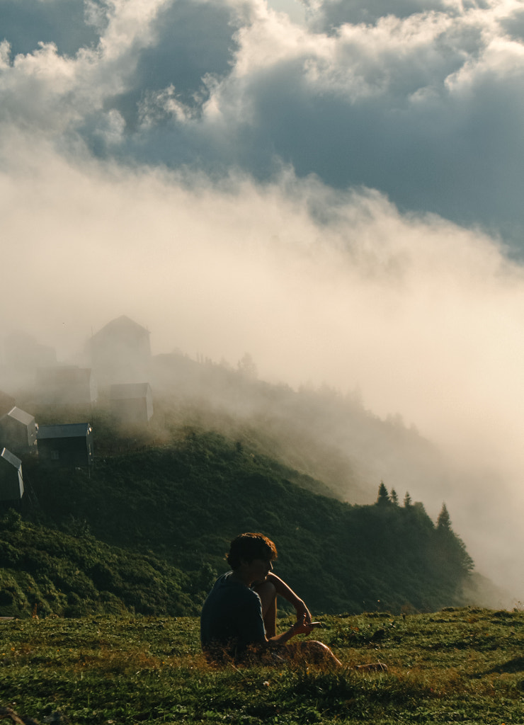 Rear view of man photographing on field against sky by Nika Pailodze on 500px.com