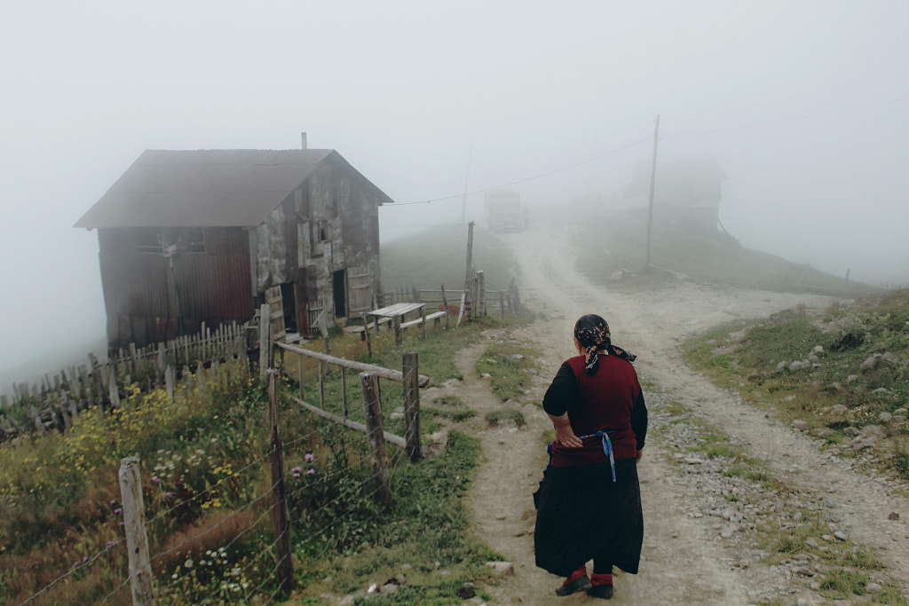 Rear view of woman standing on footpath during foggy weather by Nika Pailodze on 500px.com