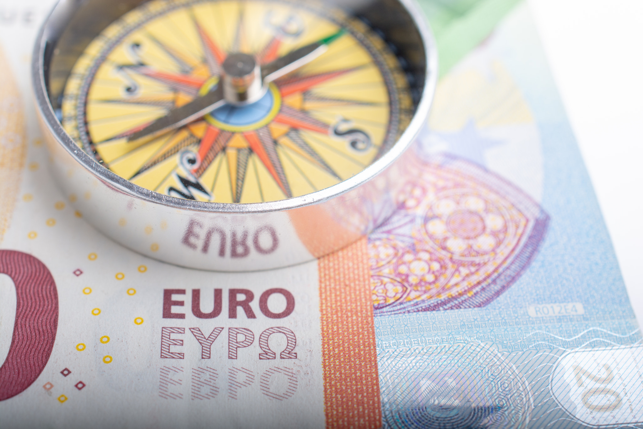 Compass and Euro banknotes as business, currency finance  concept