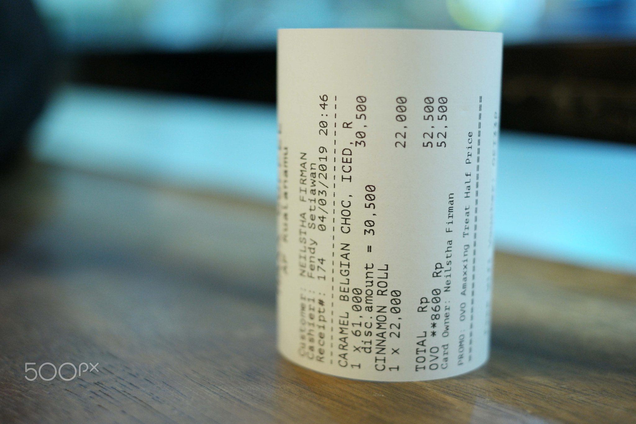 Grocery shopping roll printout on a wooden table