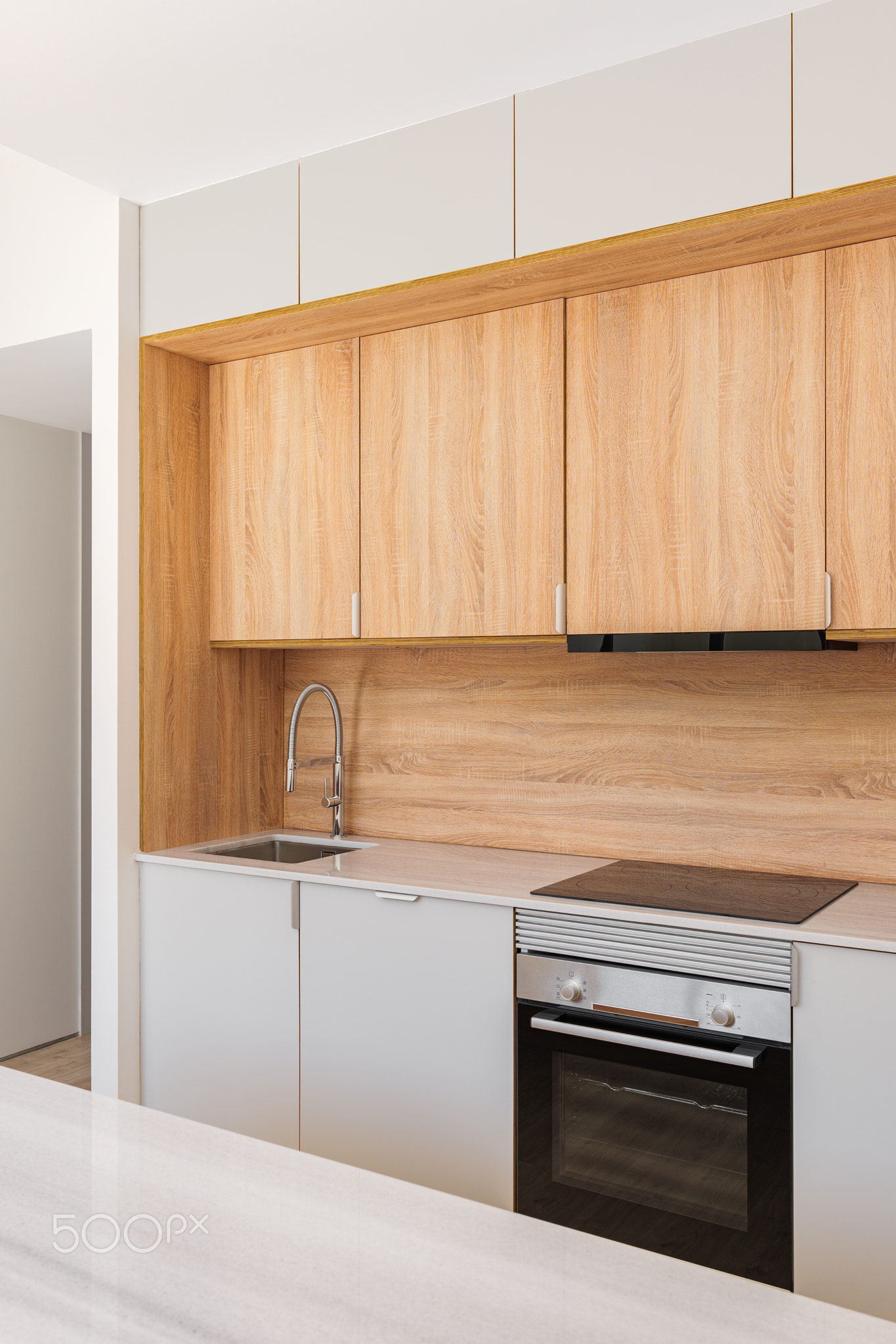 Modern kitchen with wooden furniture, gray countertop and built-in