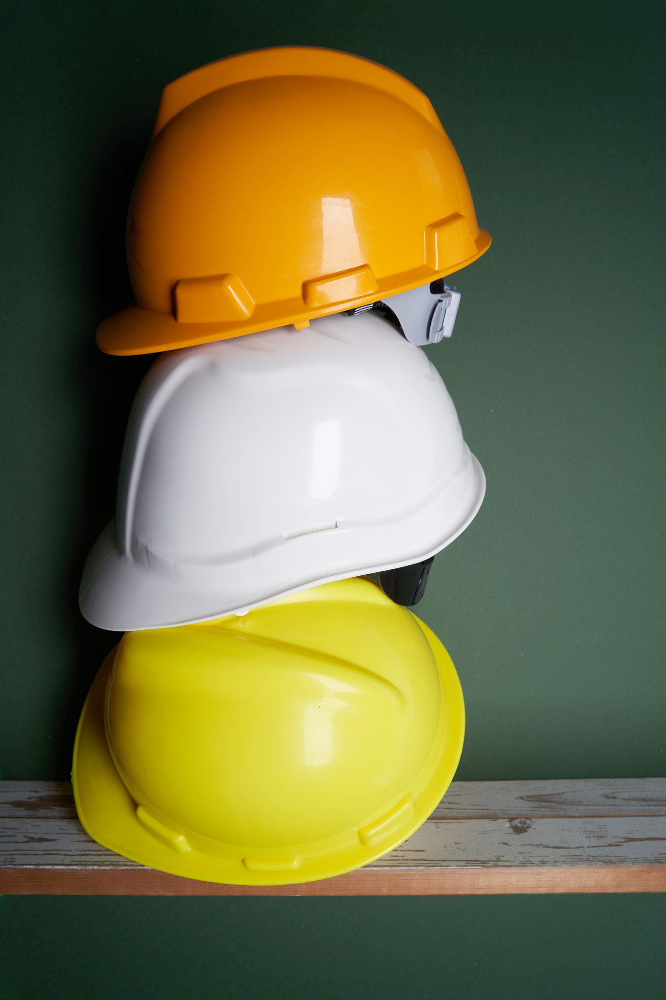 construction helmet on shelf against green background