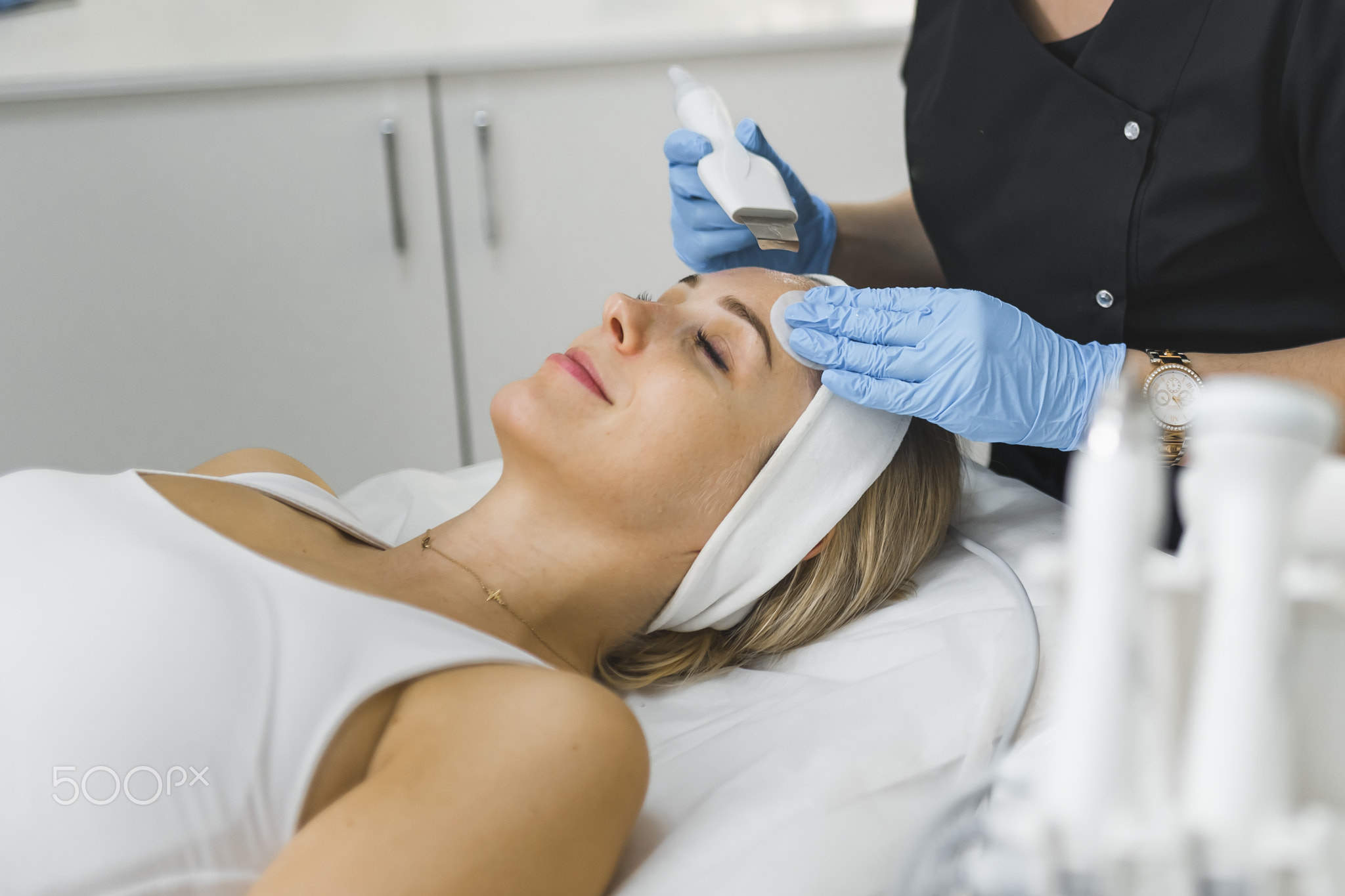 Side-view of a face of a woman laying down with her eyes cosed and