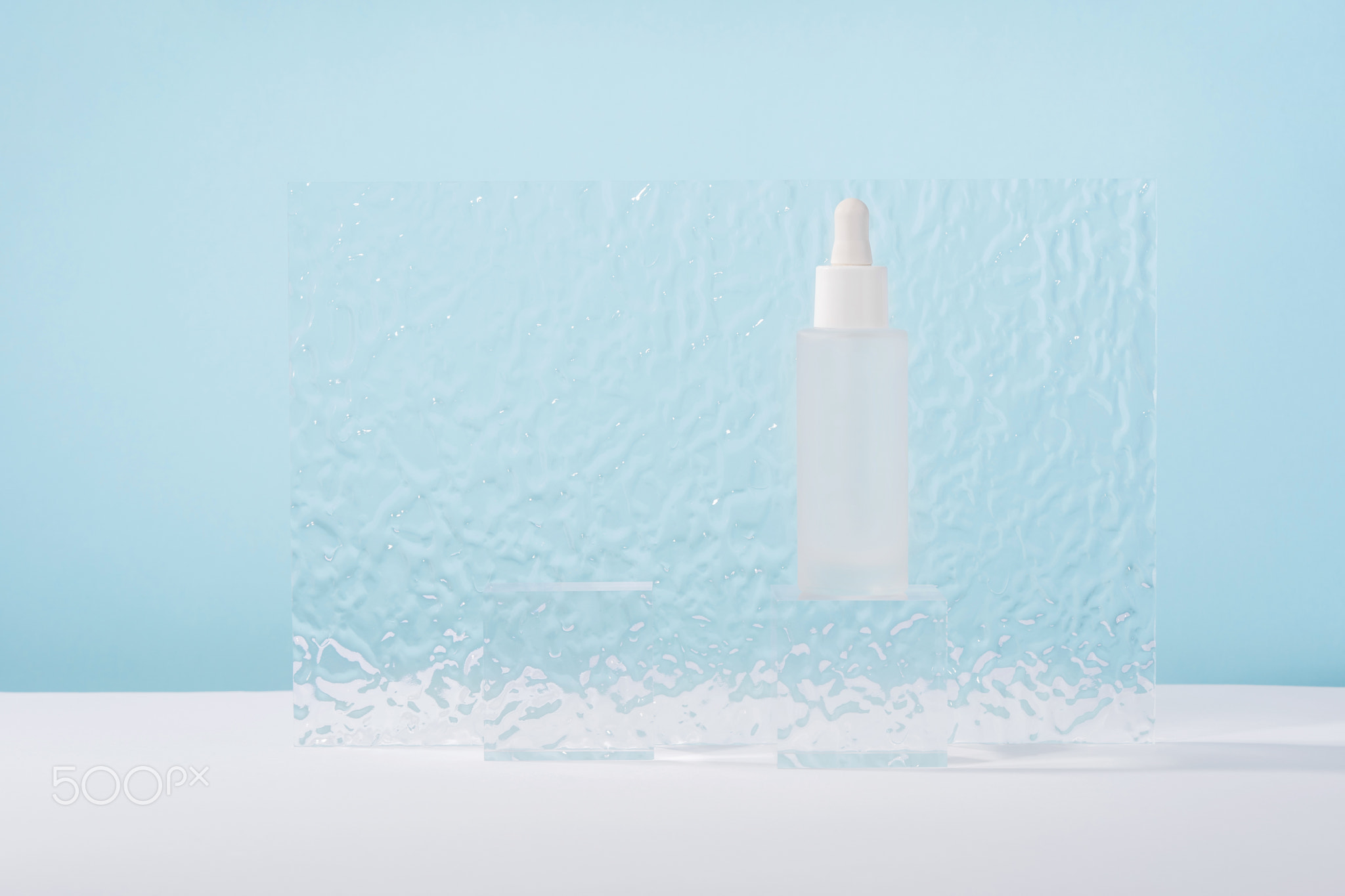 Serum cosmetic bottle with peptides and retinol on acrylic blocks on