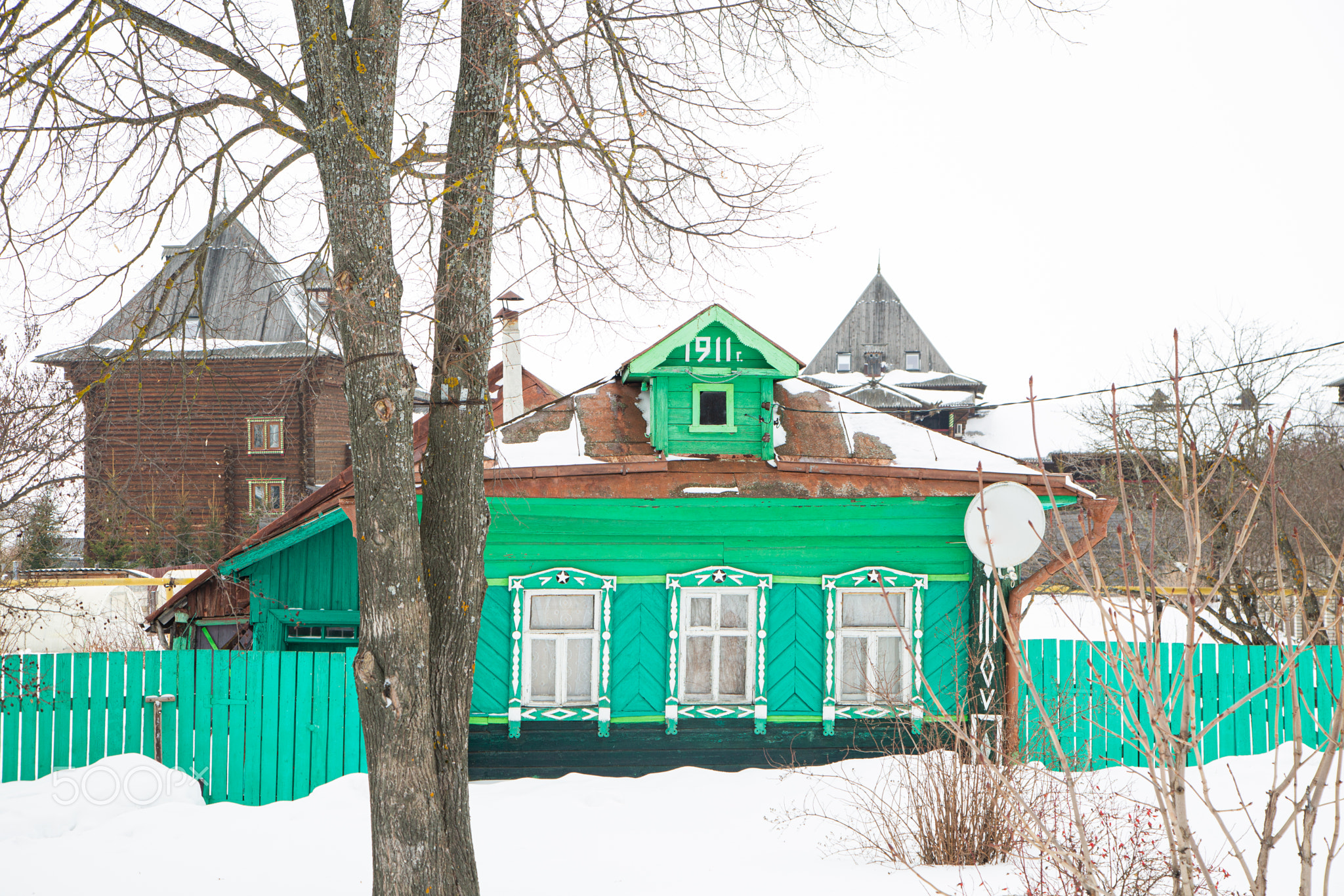 A Russian wood house covered in snow