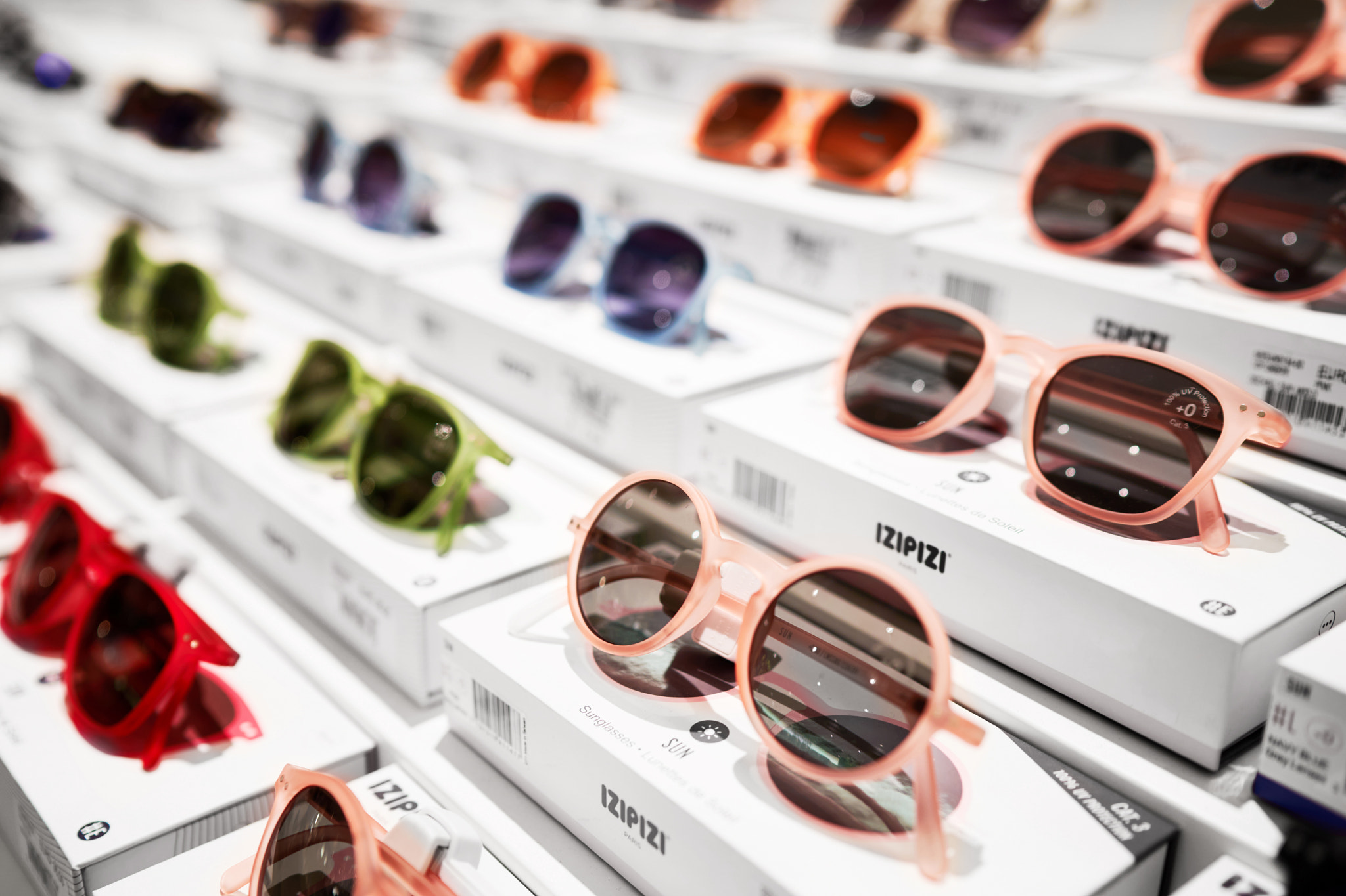 Sunglasses stand on the shop shelf.