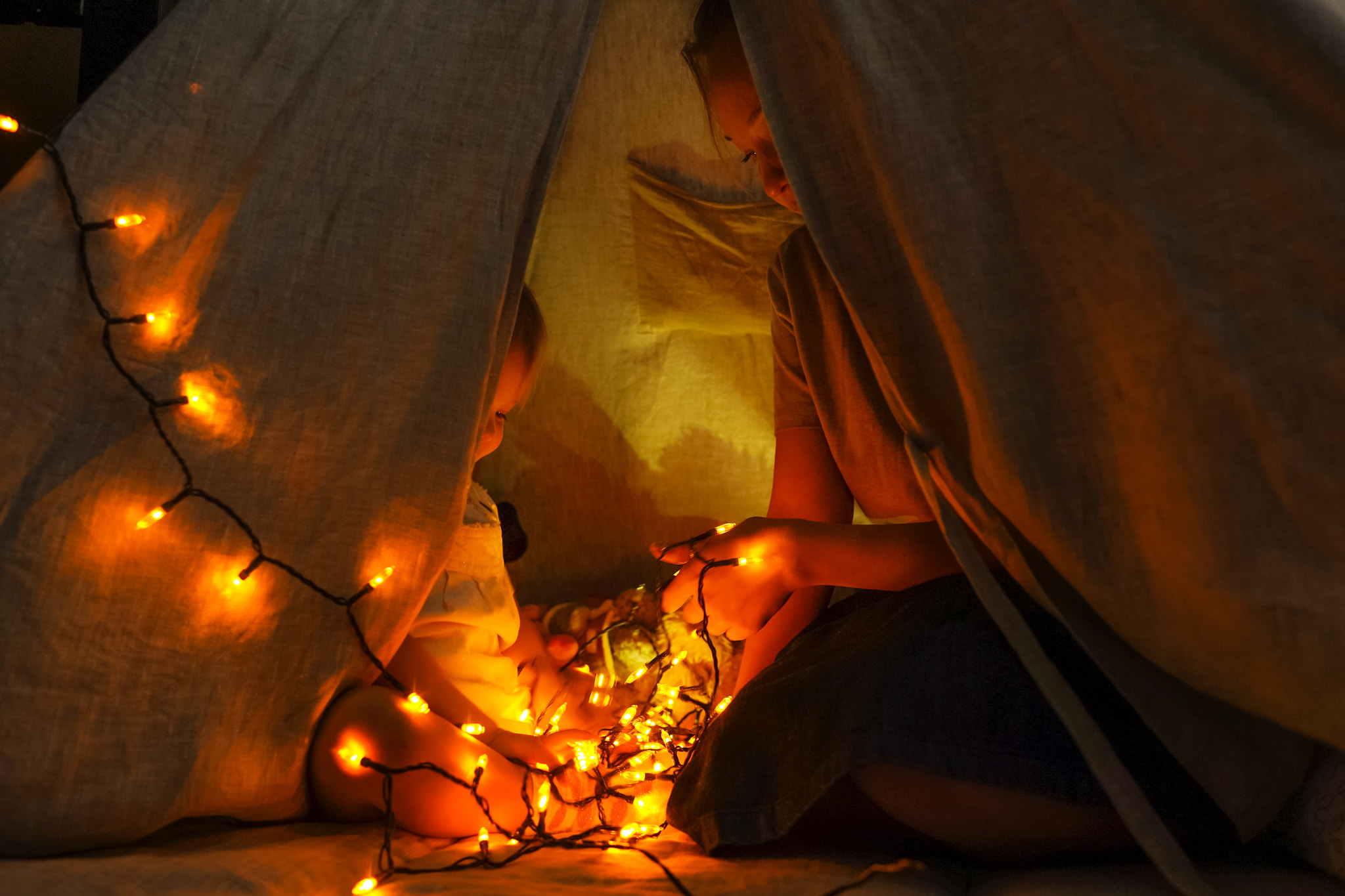 Magic tent with garland home, people inside.