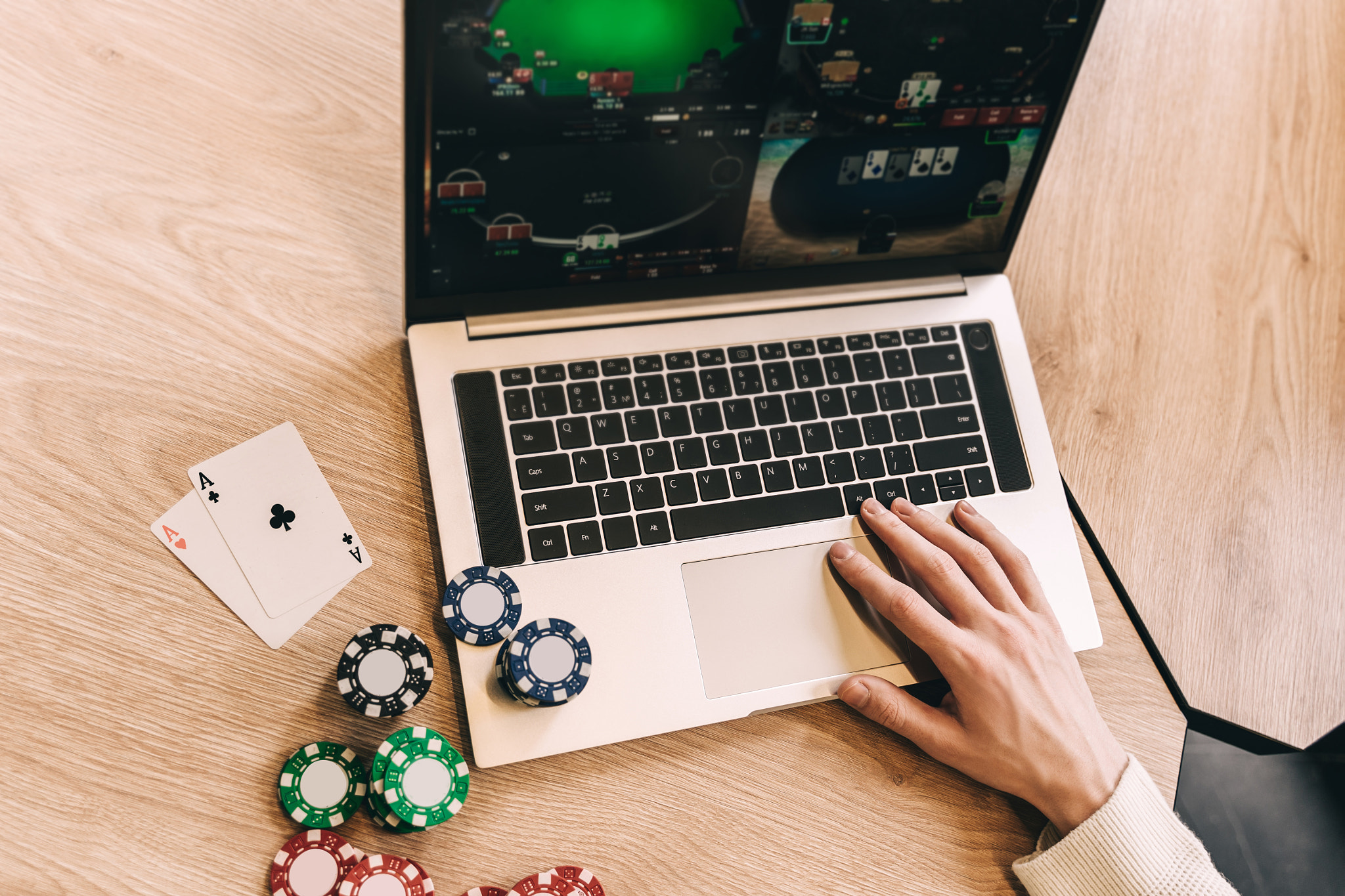 Young man play online poker in laptop.