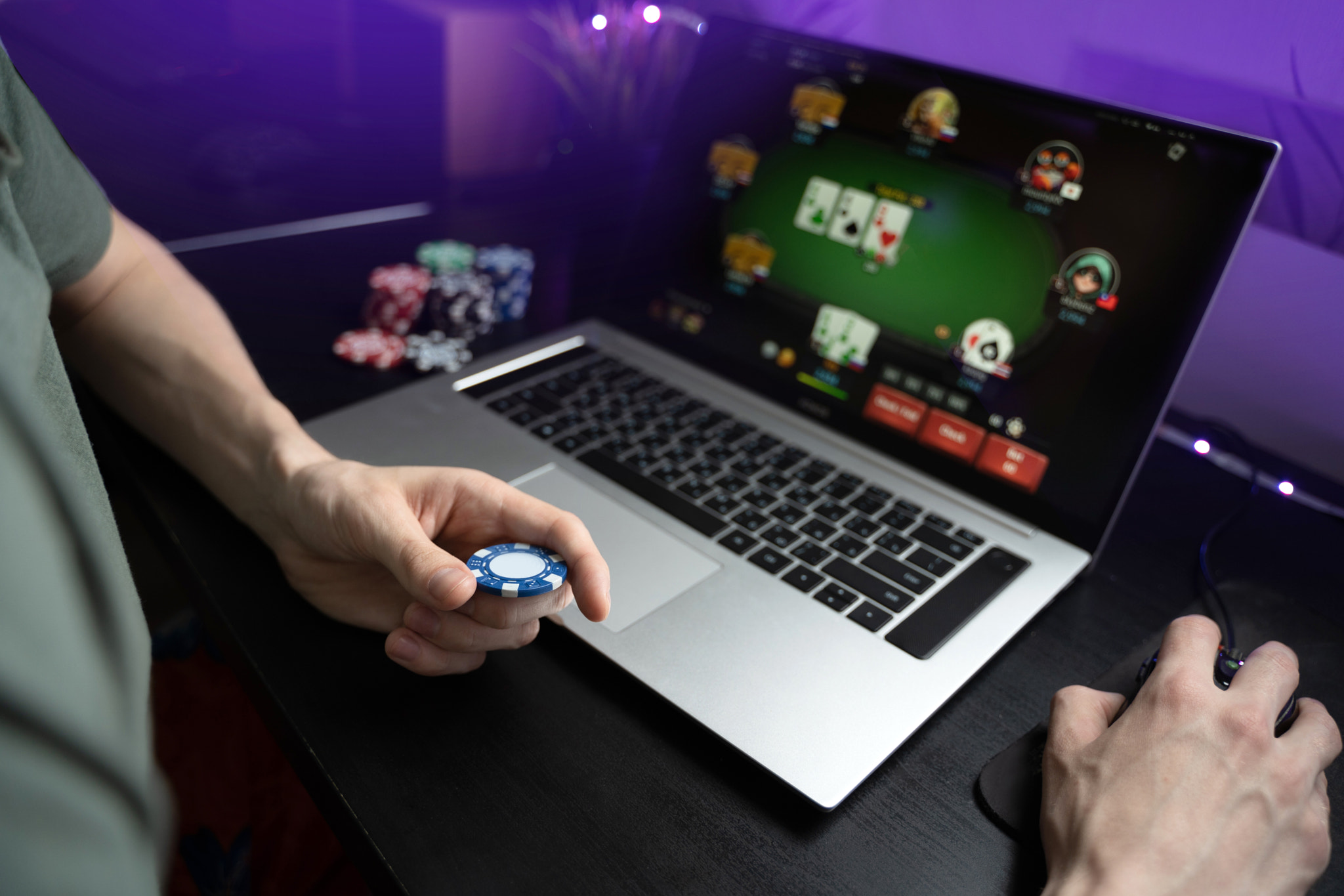 Young man play online poker in laptop.