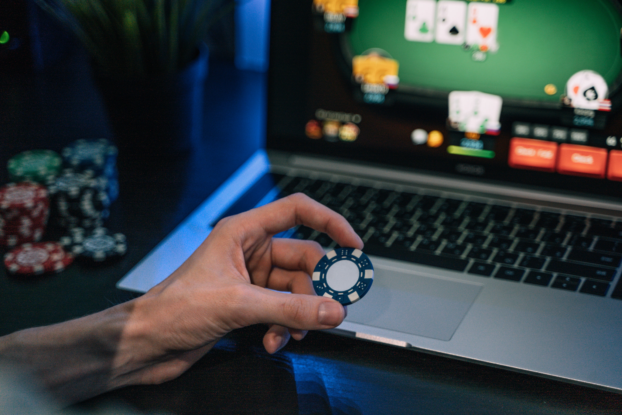 Young man play online poker in laptop.