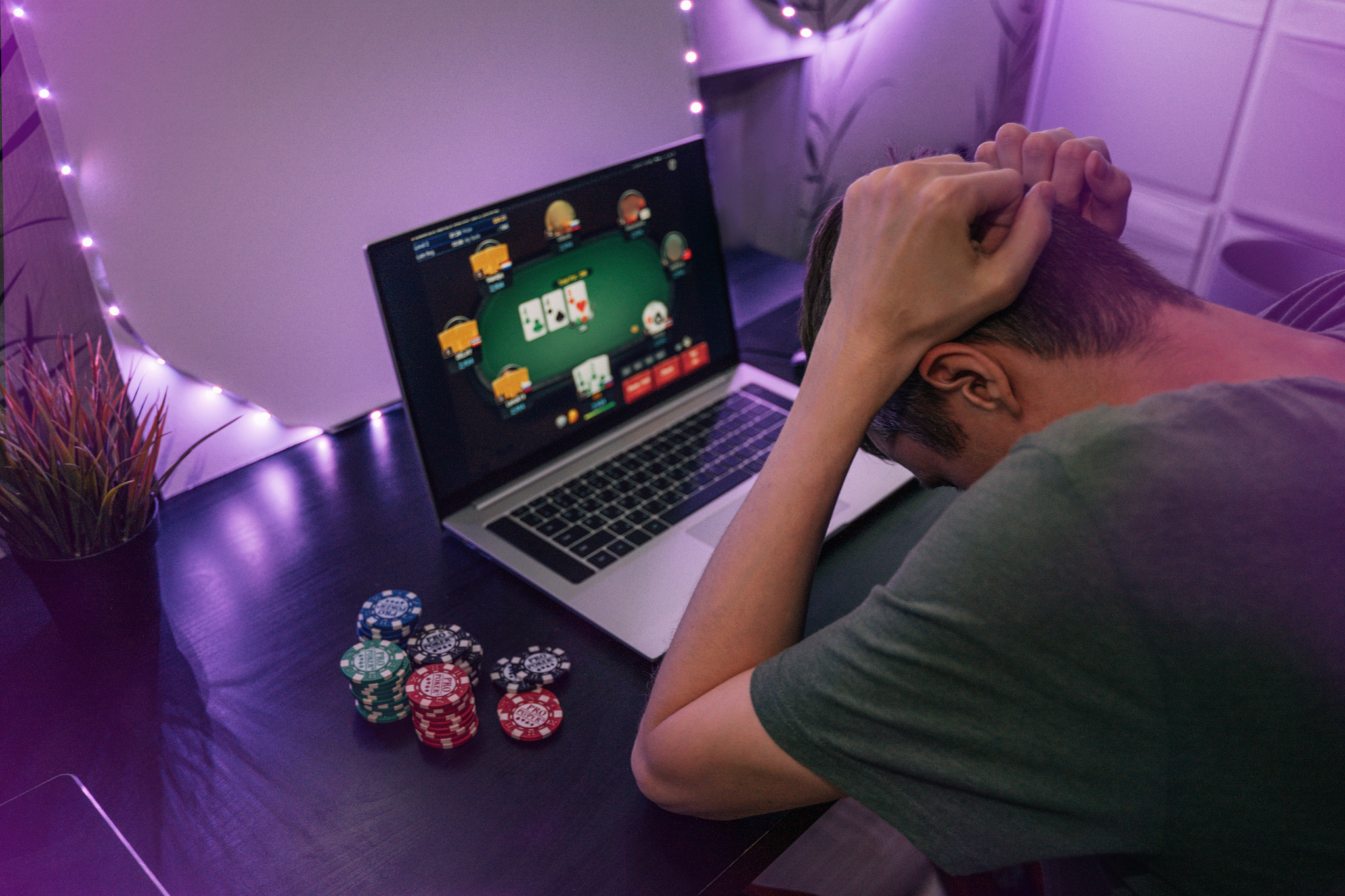 Young man play online poker in laptop.