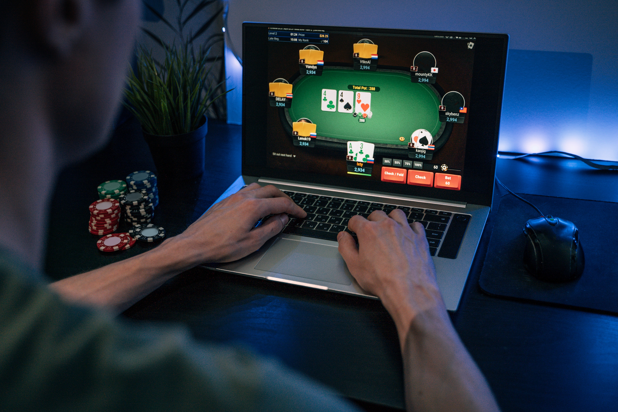 Young man play online poker in laptop.