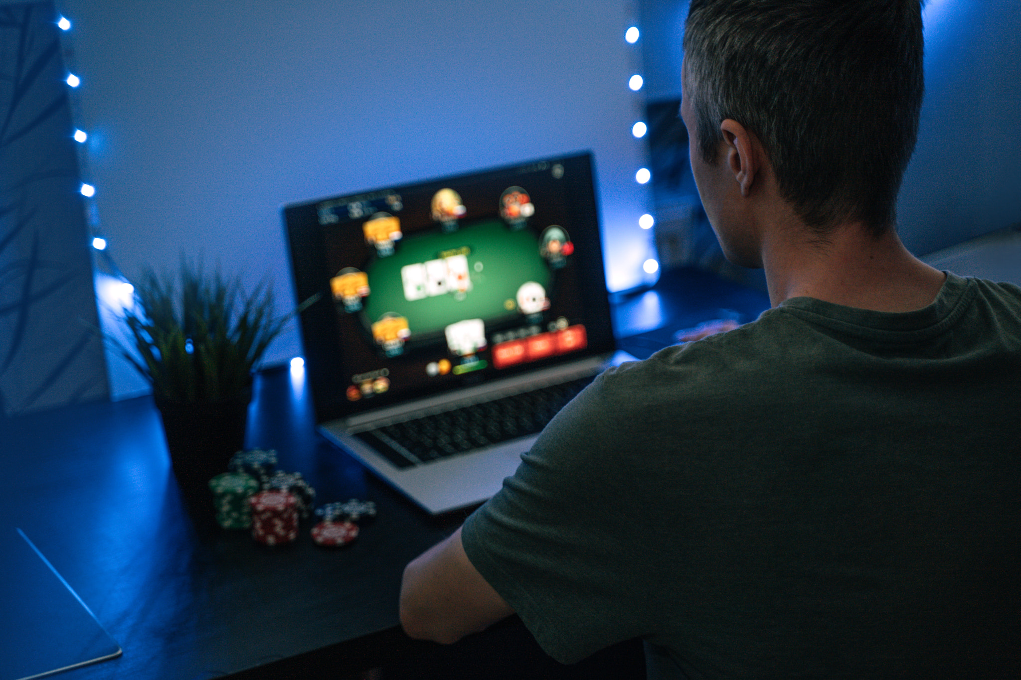 Young man play online poker in laptop.