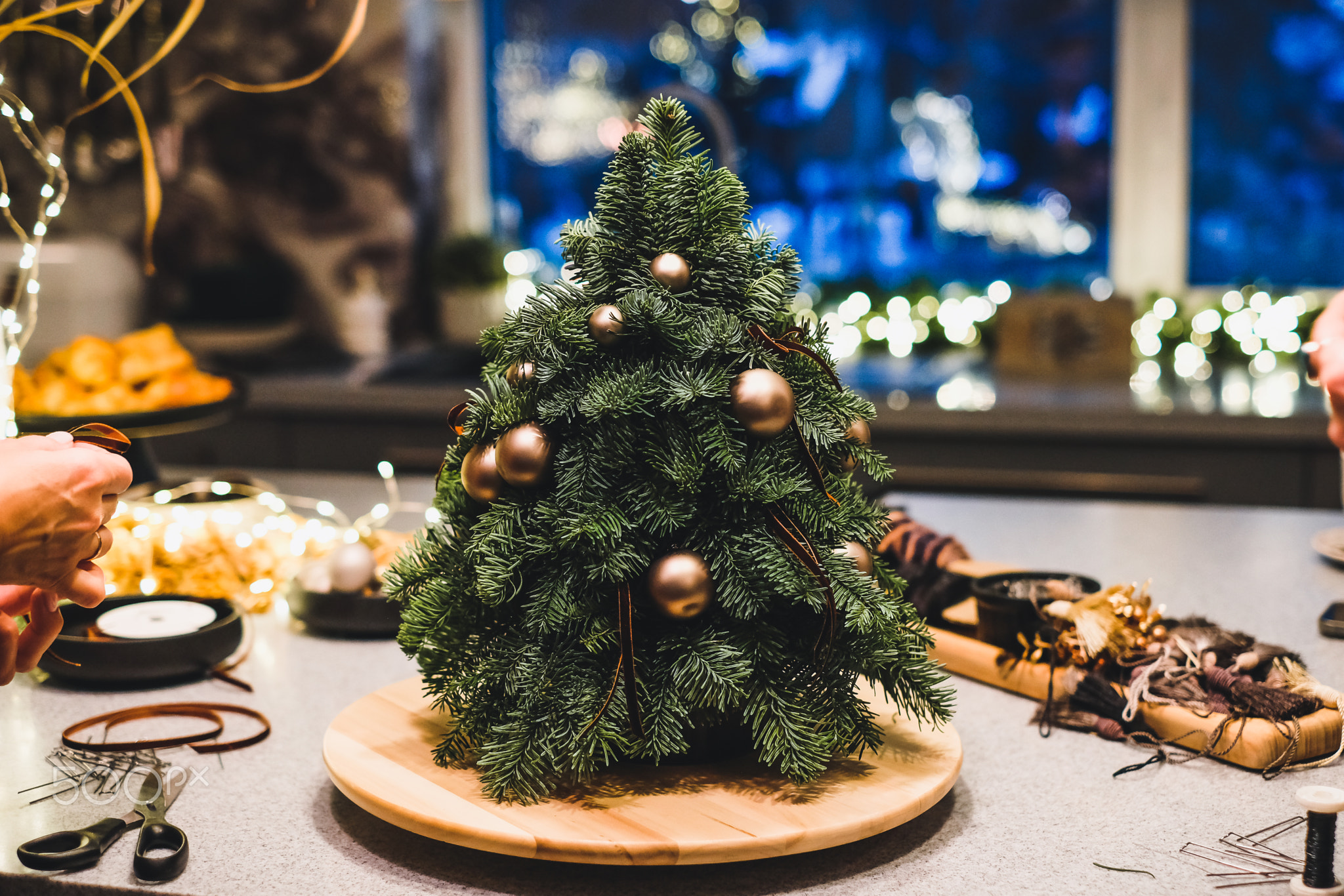 Small portable tabletop easy DIY decorated Christmass tree. Defocused