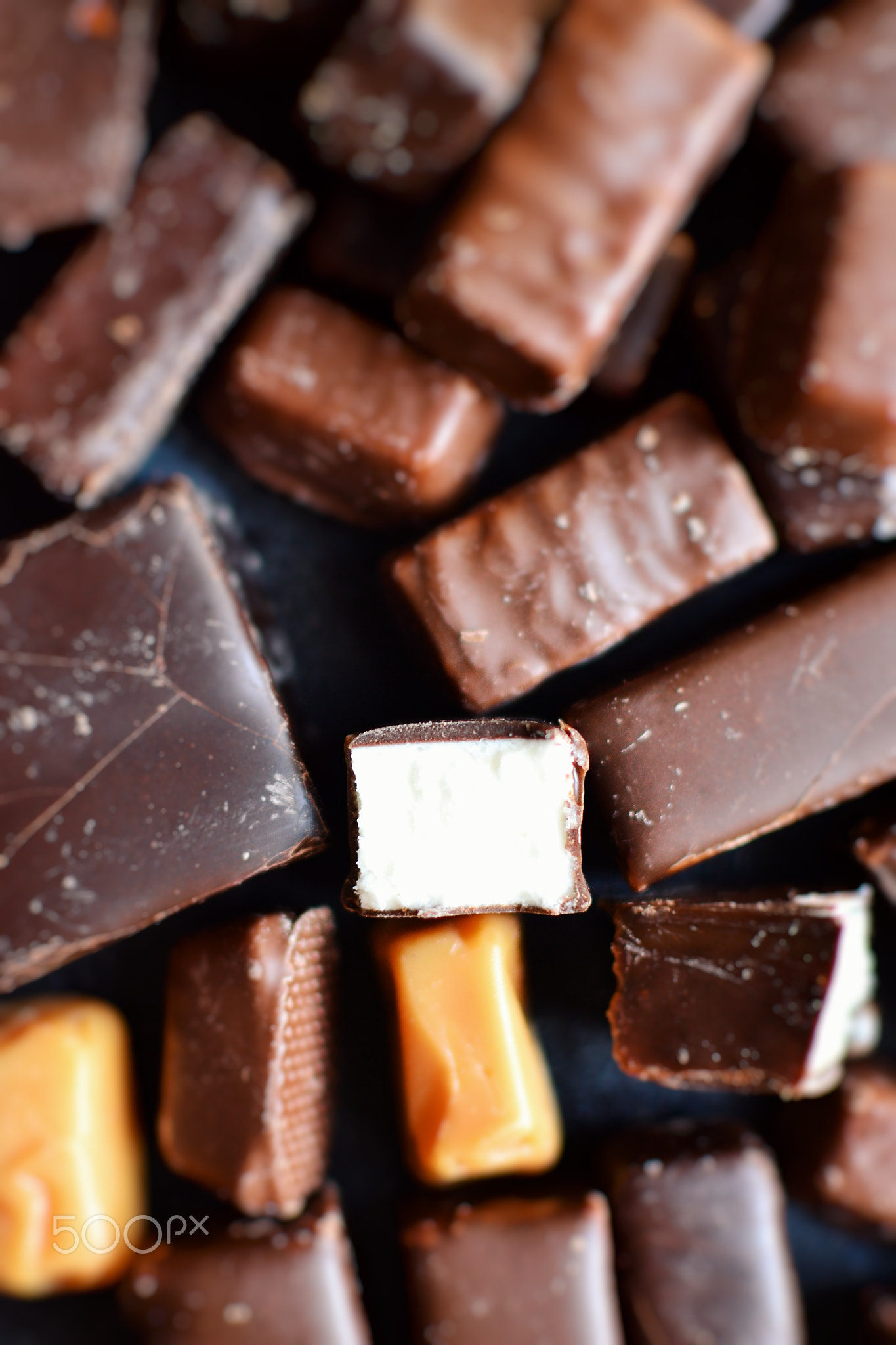 Assortment of chocolates. Candies closeup. Top view place for text. Dark chocolate. Chocolate bars.