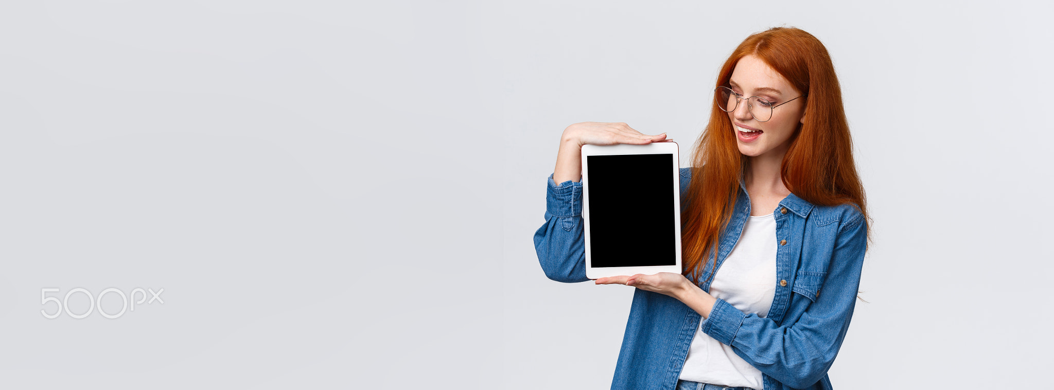 Technology and people concept. Attractive creative young redhead girl