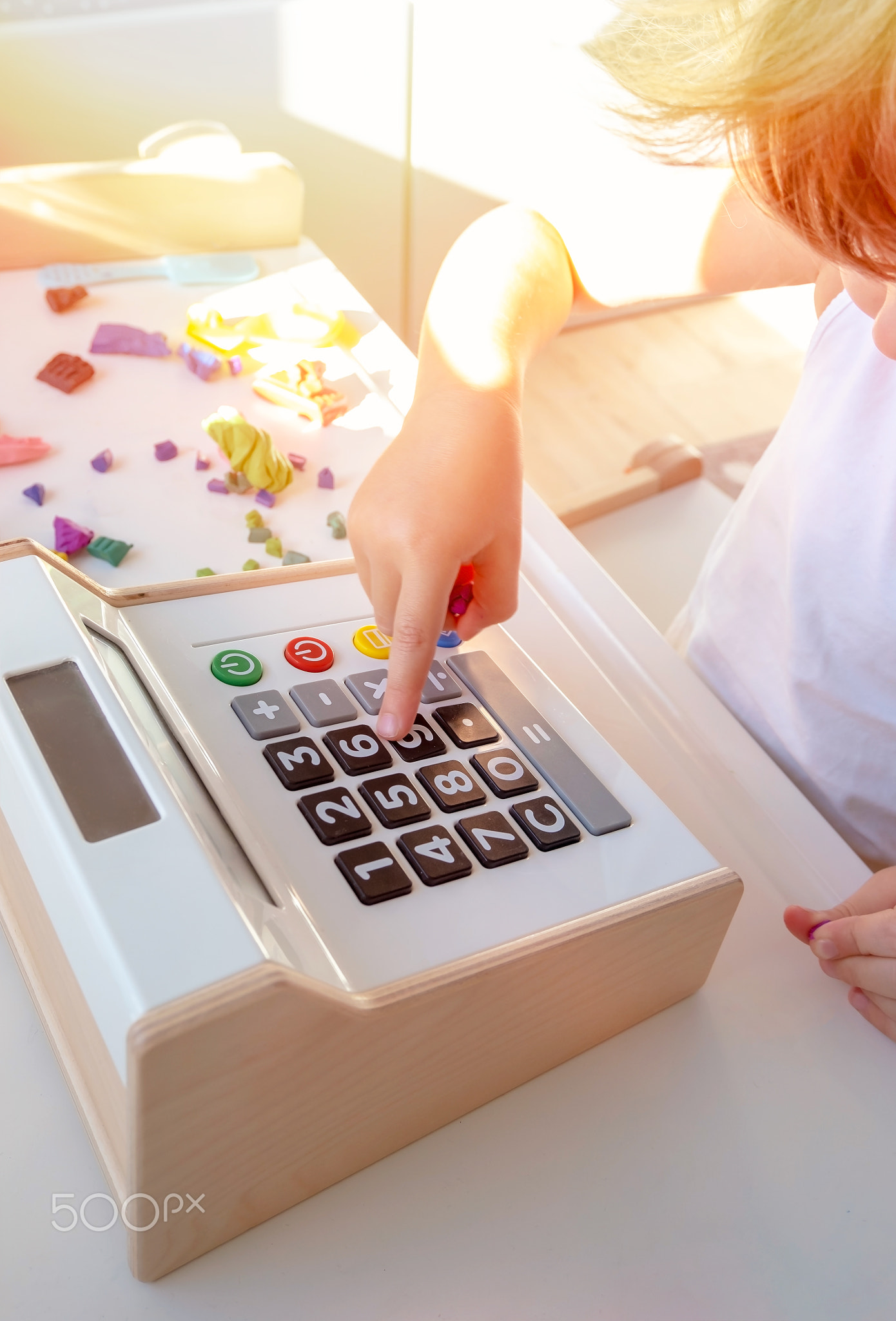 Close up of kid's finger is pressing to open the cash drawer toys in