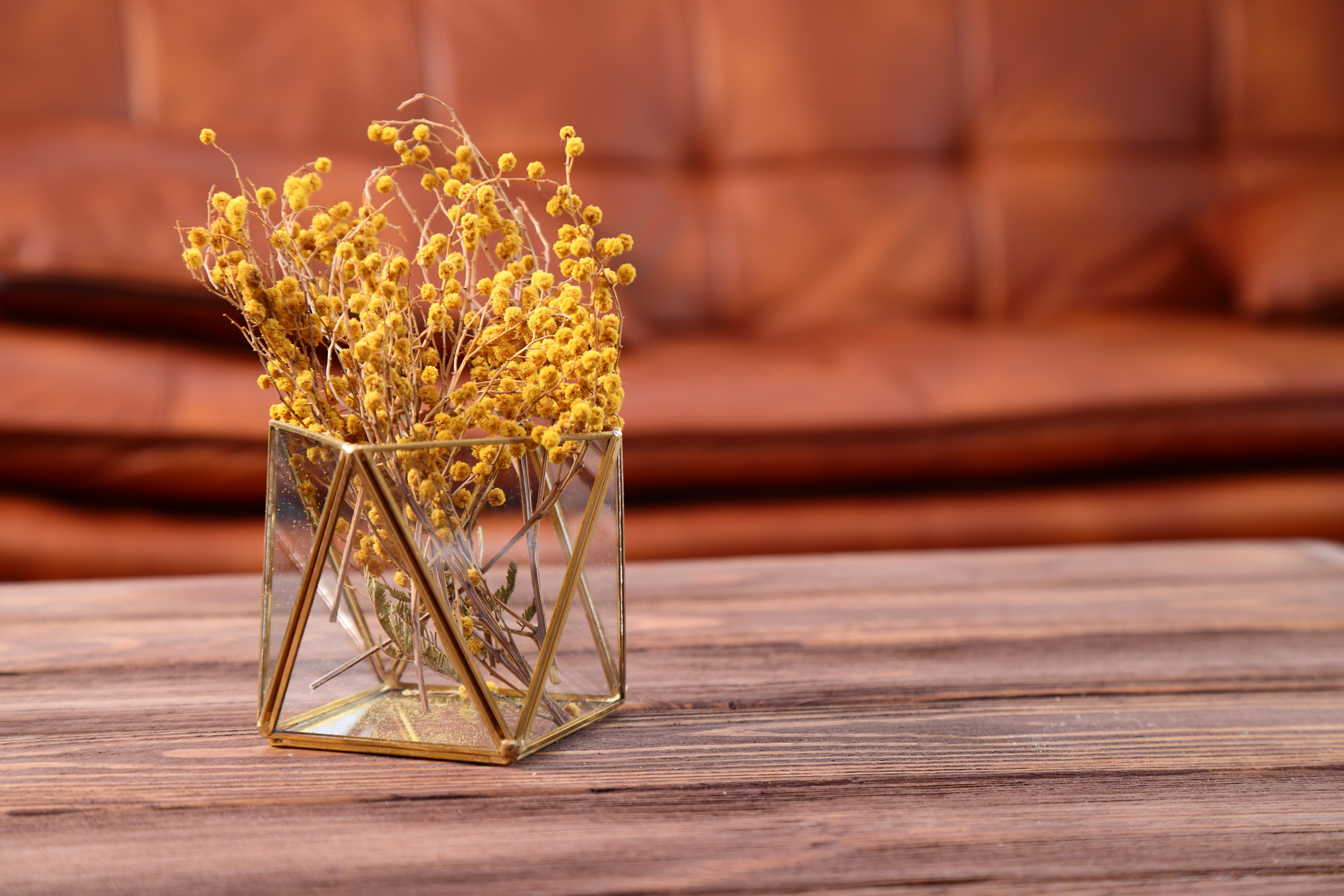 Small flowers on wooden table in living room