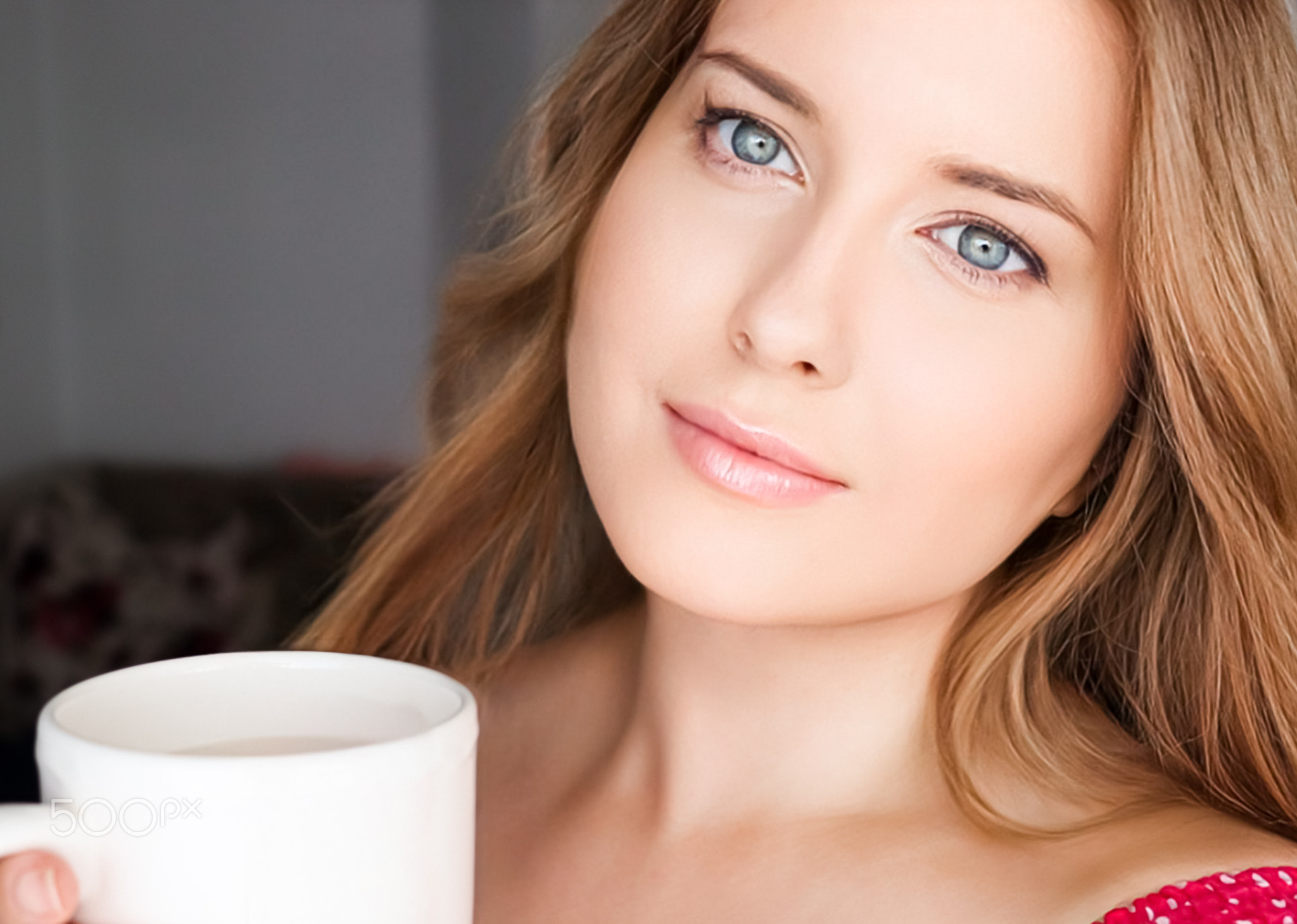 Beautiful woman having a cup of tea in the morning at home