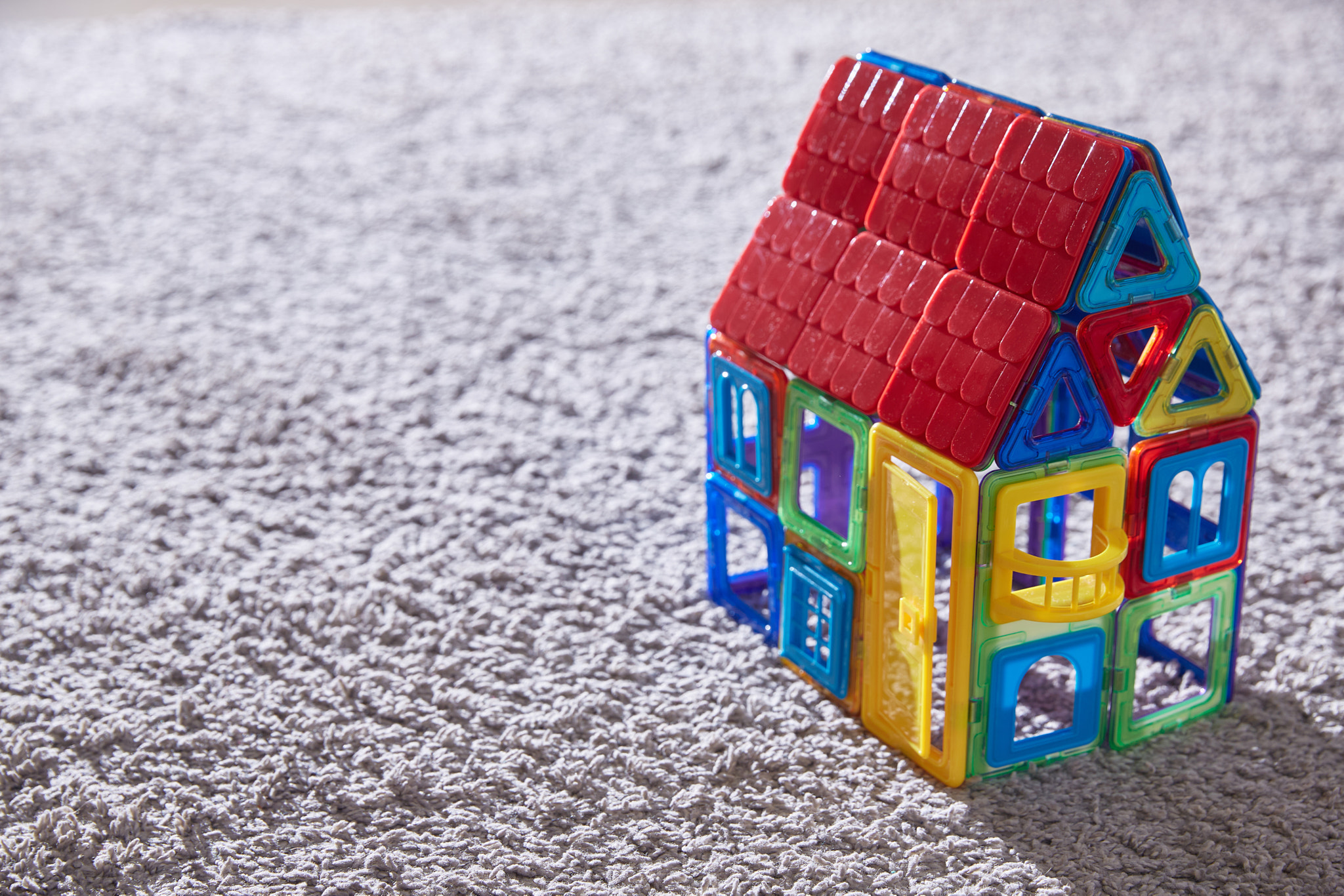 House toy constructor on the carpet. Copy space