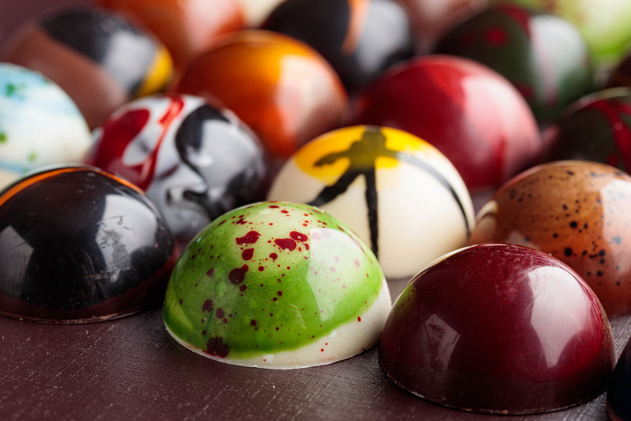 Assortment of painted handcrafted chocolate bonbons. Delicious dessert