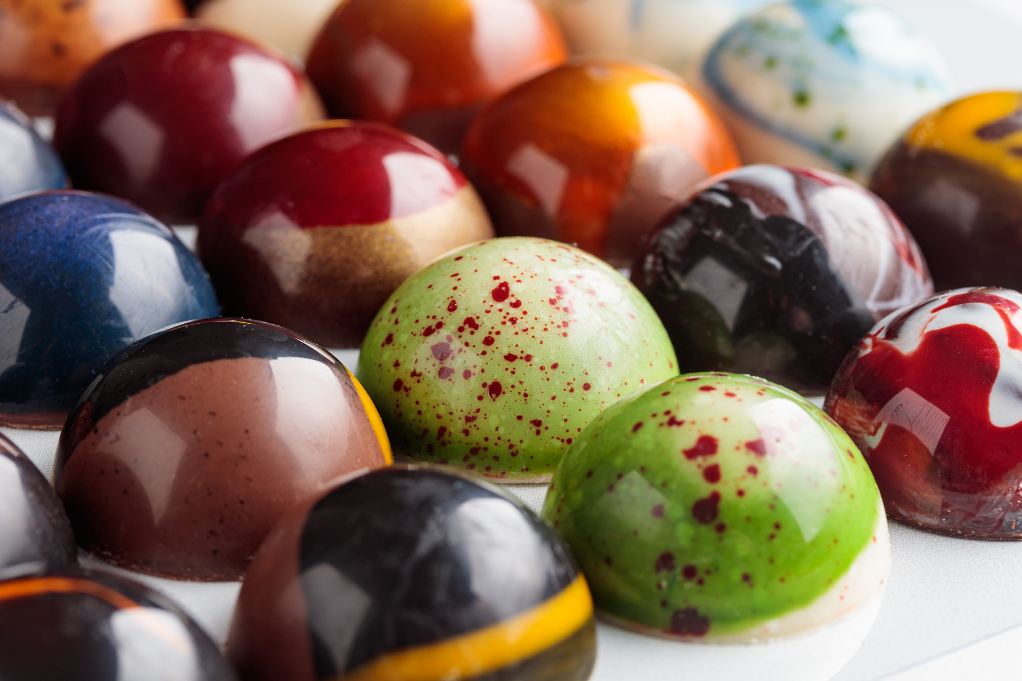 Assortment of painted handcrafted chocolate bonbons. Delicious dessert